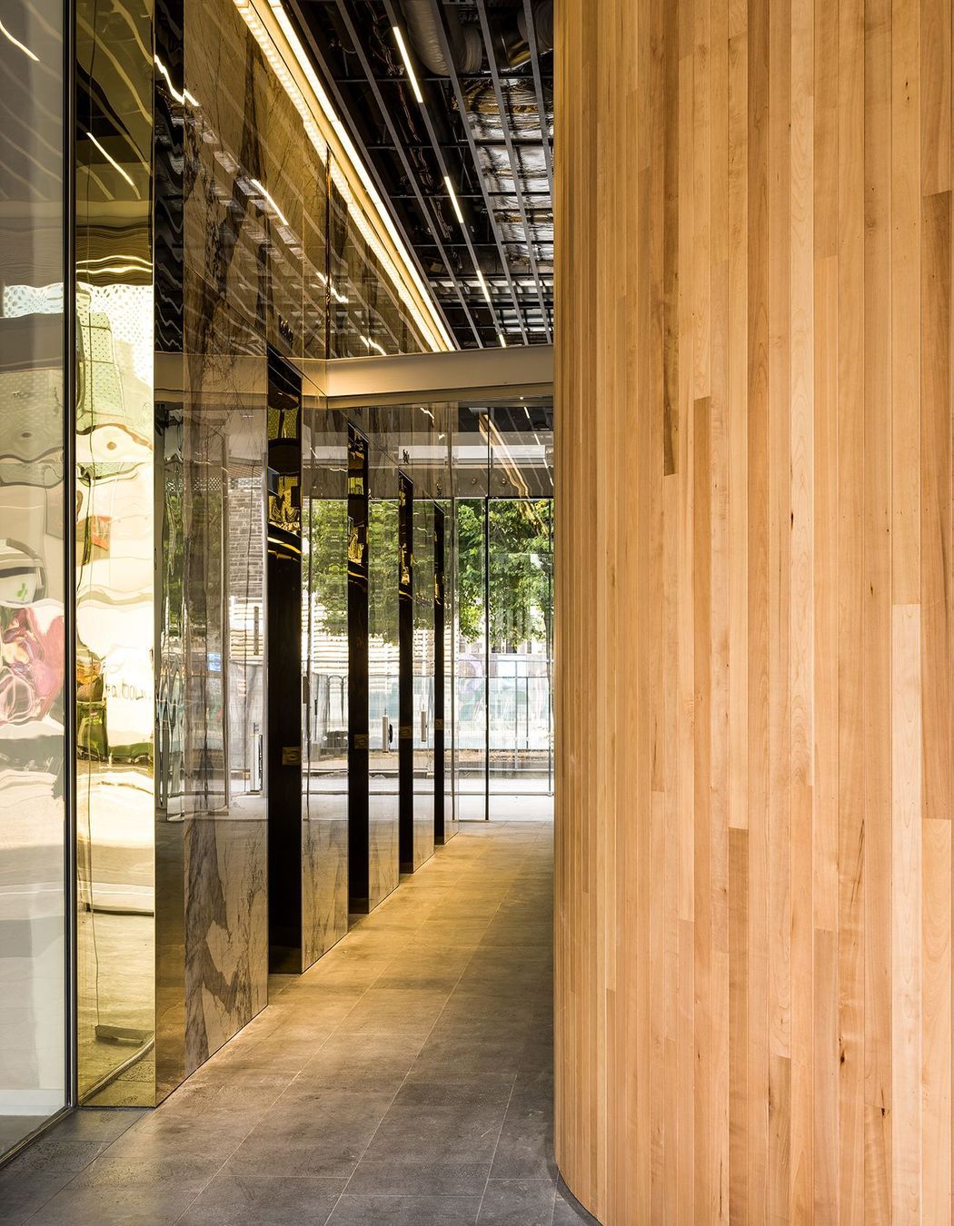 Curvaceous timber surfaces add texture and warmth against shiny surfaces.