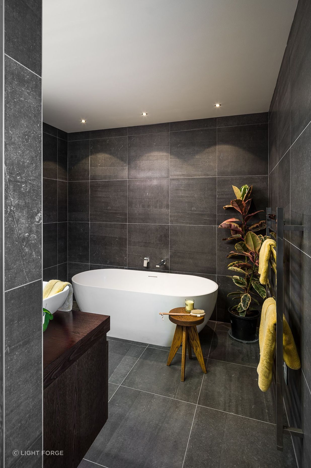 Large-format tiles add a sense of drama to this bathroom and reinforce the dichromatic colour scheme.