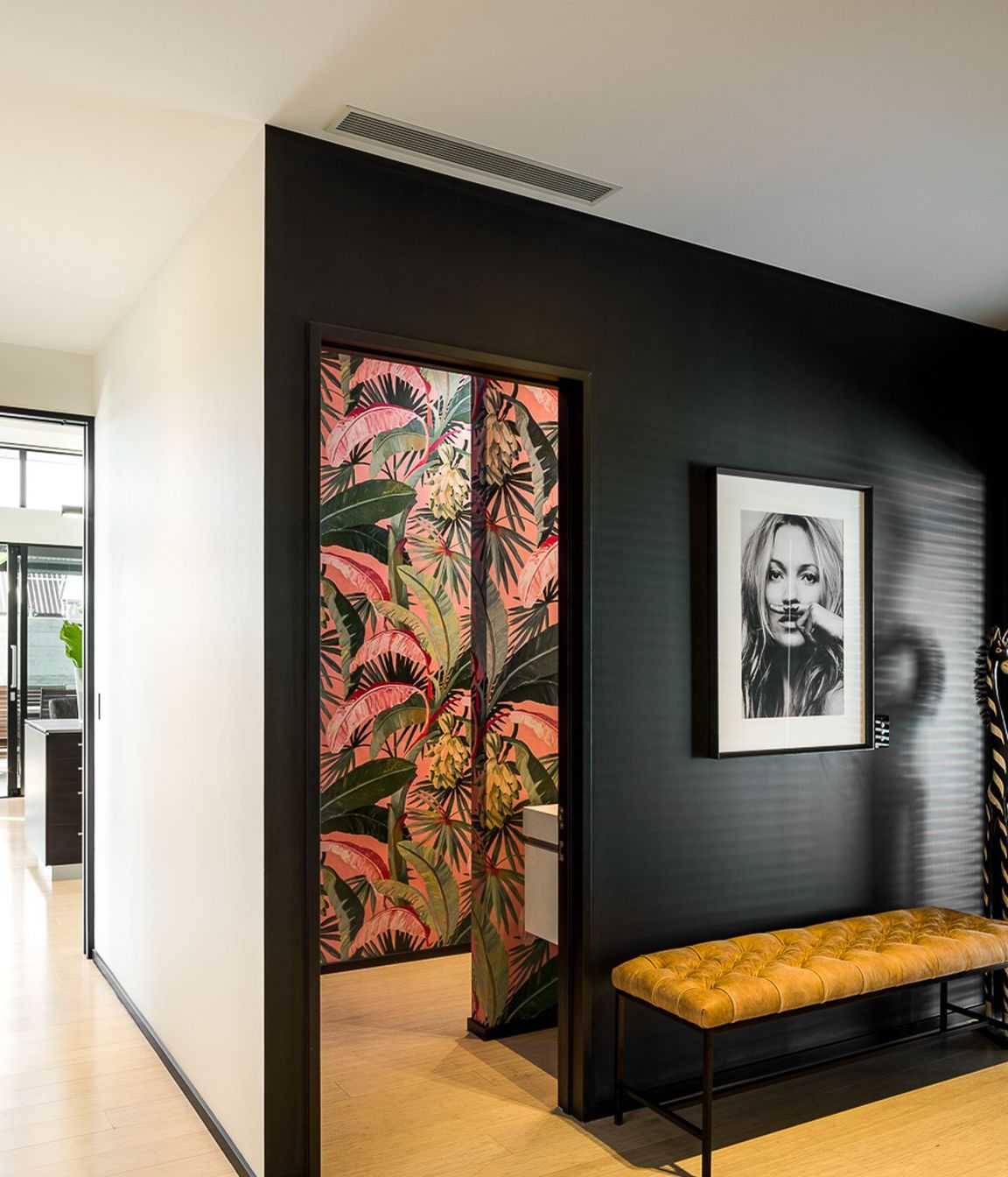 A vibrant botannical print in the powder room adds a splash of colour to the interior design scheme.