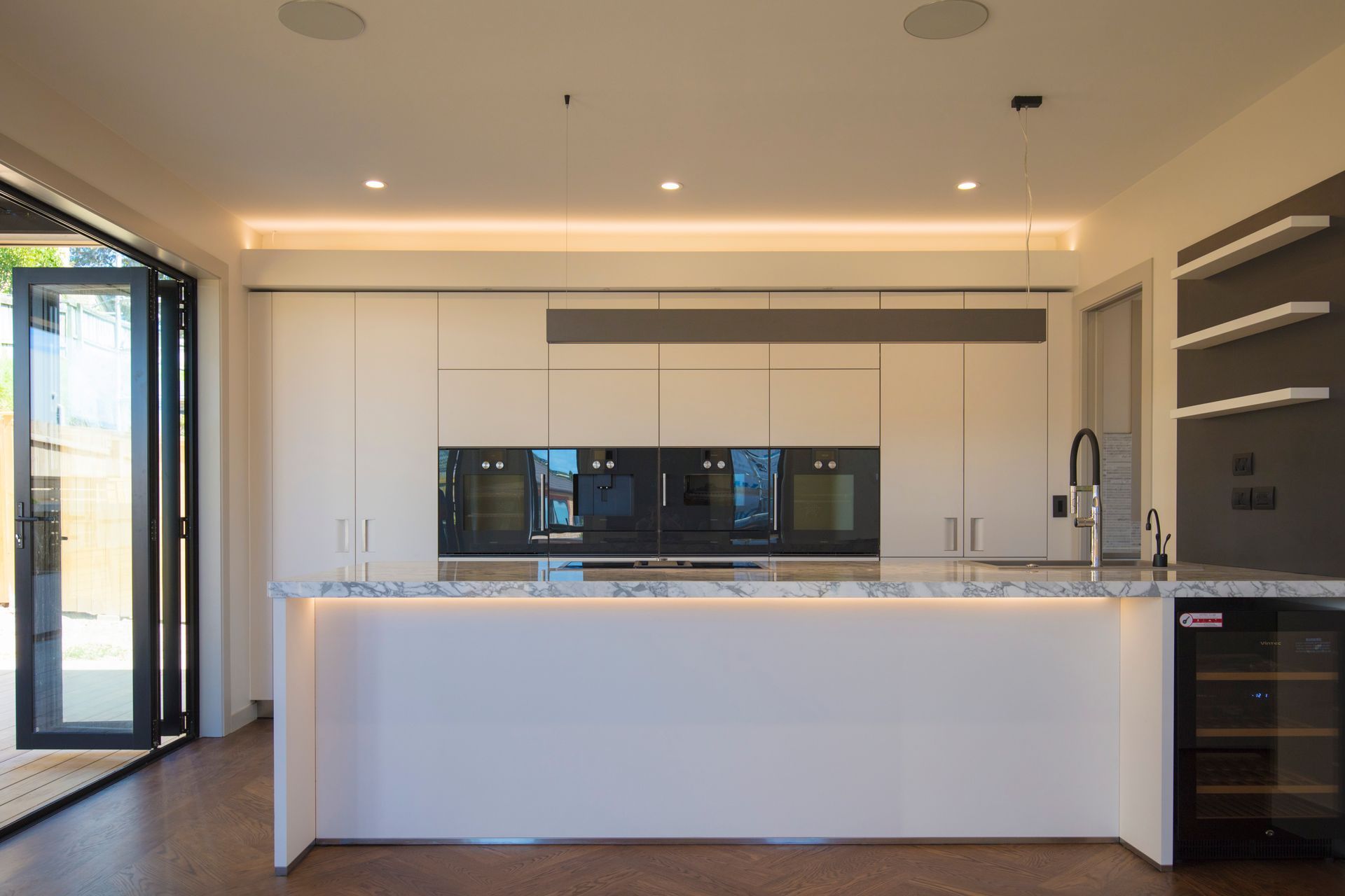 Lagonda Rise - Prime Grade Solid American White Oak in Herringbone Parquet w/ a two plank border and finished with a stain in 'Jacobean' and Waterborne Polyurethane