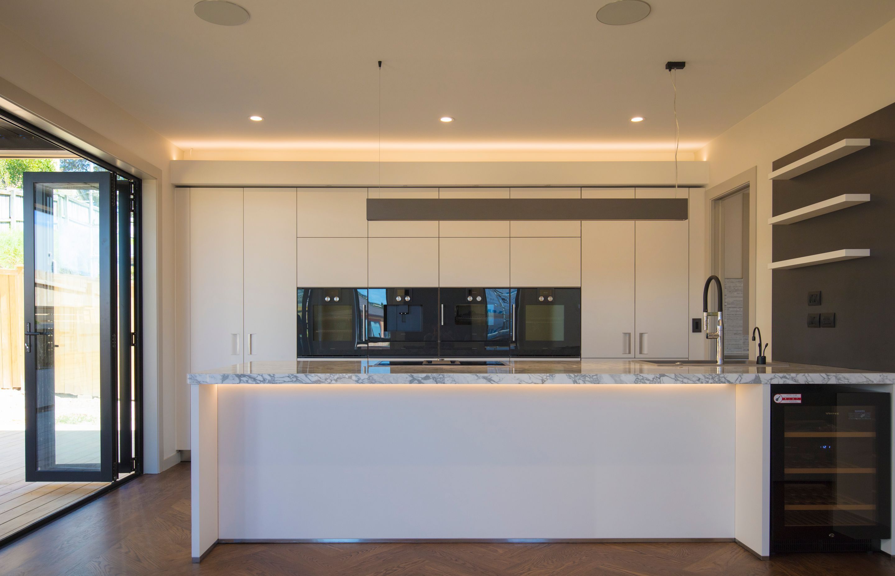 Lagonda Rise - Prime Grade Solid American White Oak in Herringbone Parquet w/ a two plank border and finished with a stain in 'Jacobean' and Waterborne Polyurethane