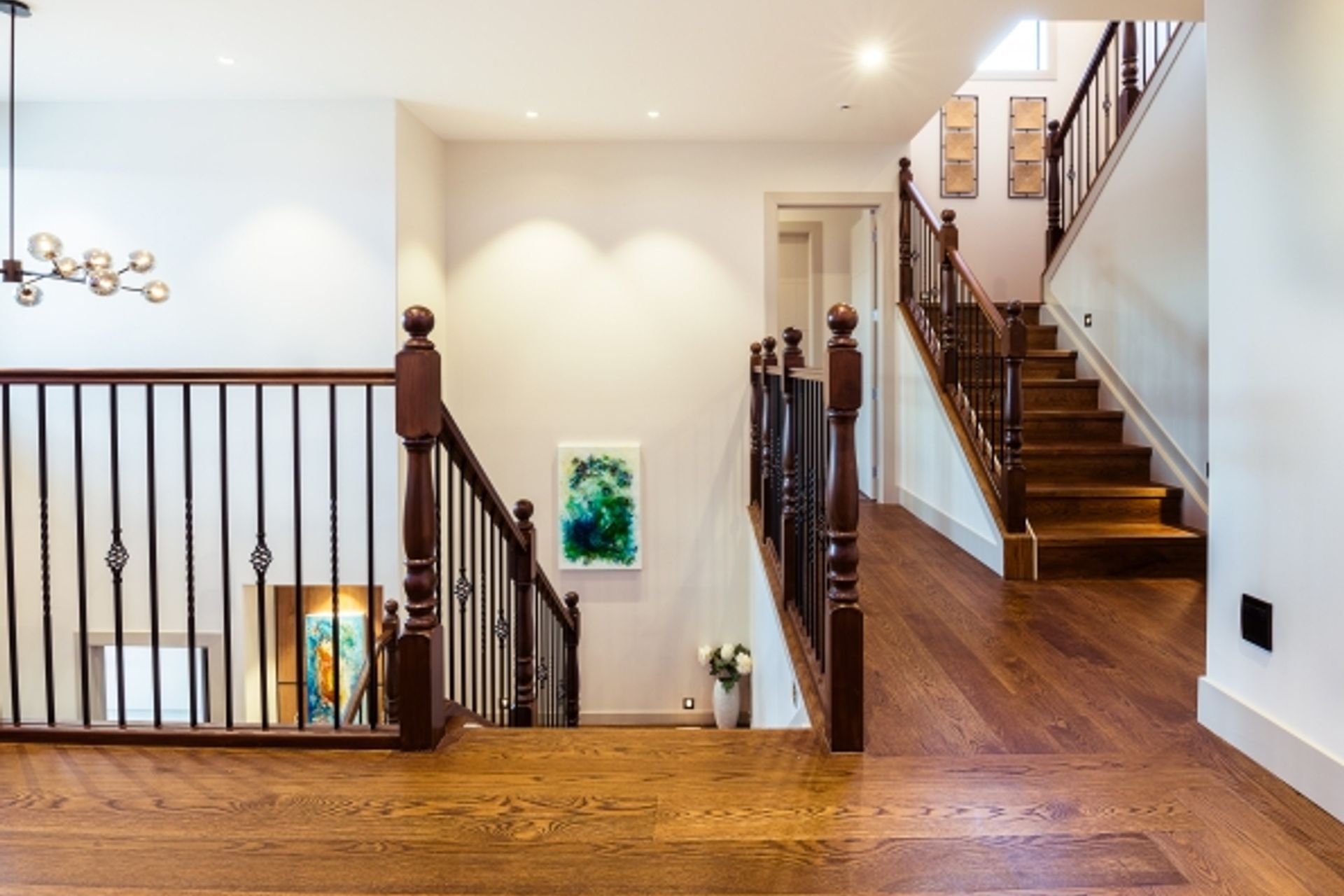 Lagonda Rise - Prime Grade Solid American White Oak in Herringbone Parquet w/ a two plank border and finished with a stain in 'Jacobean' and Waterborne Polyurethane