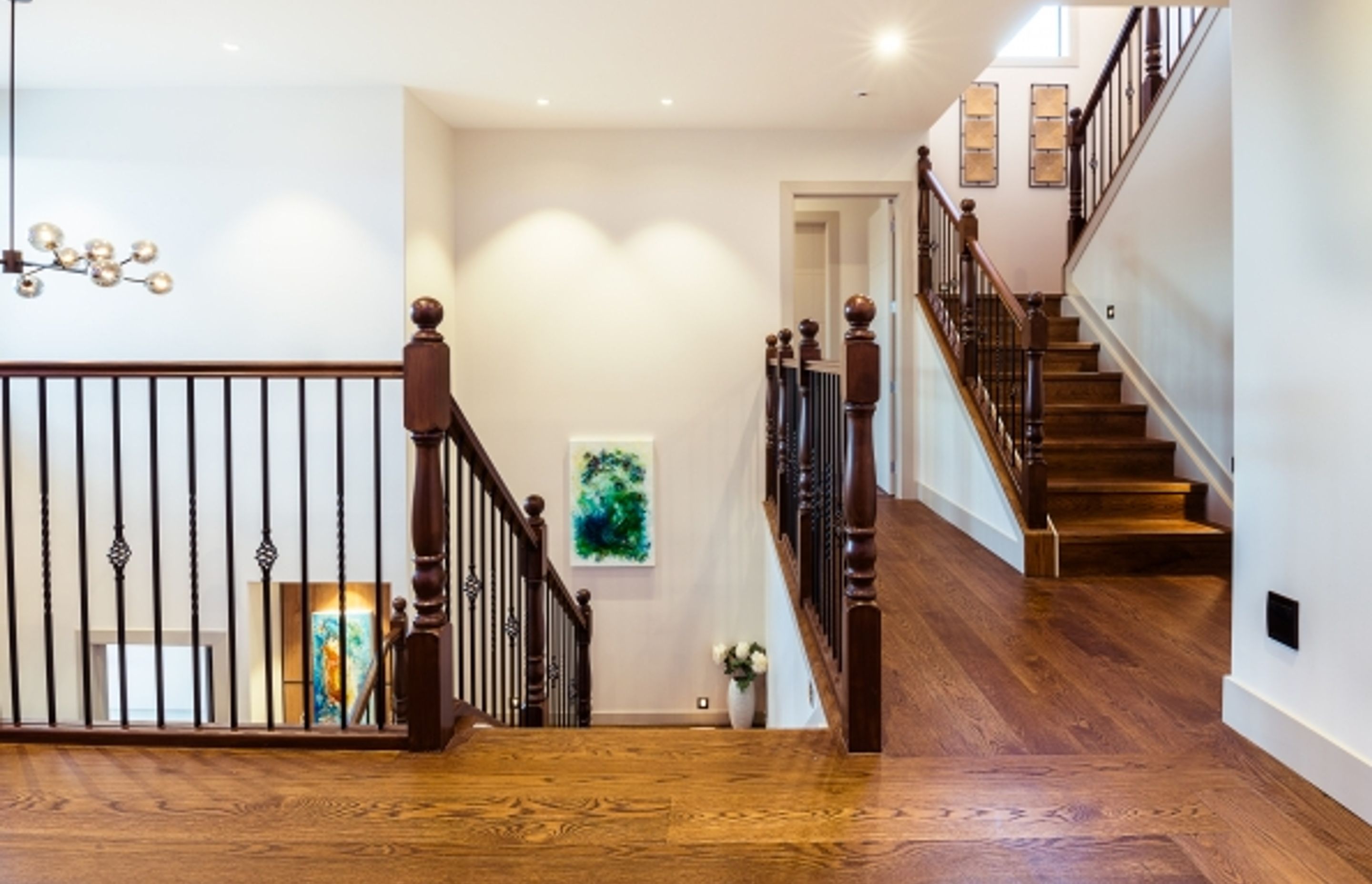 Lagonda Rise - Prime Grade Solid American White Oak in Herringbone Parquet w/ a two plank border and finished with a stain in 'Jacobean' and Waterborne Polyurethane