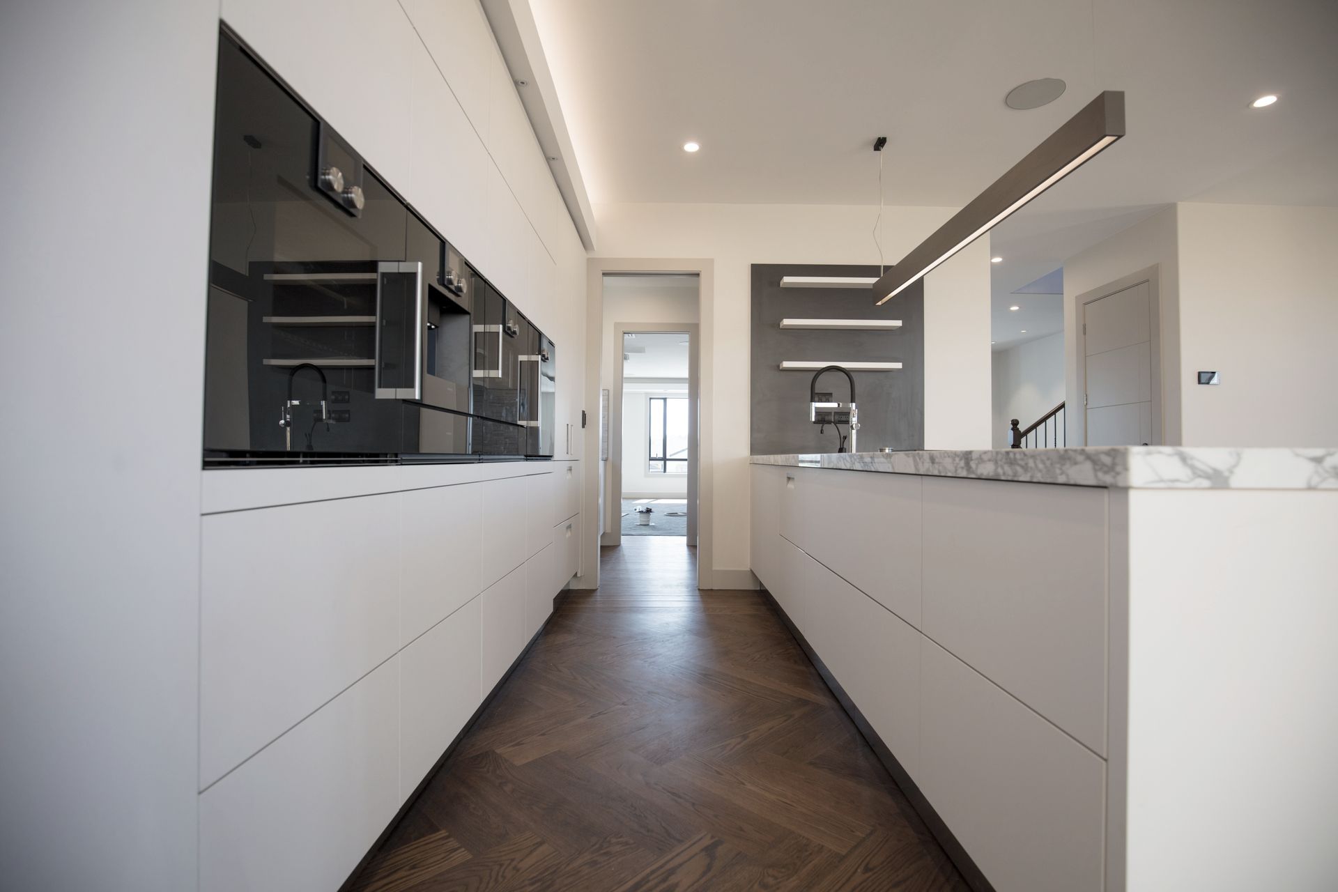 Lagonda Rise - Prime Grade Solid American White Oak in Herringbone Parquet w/ a two plank border and finished with a stain in 'Jacobean' and Waterborne Polyurethane