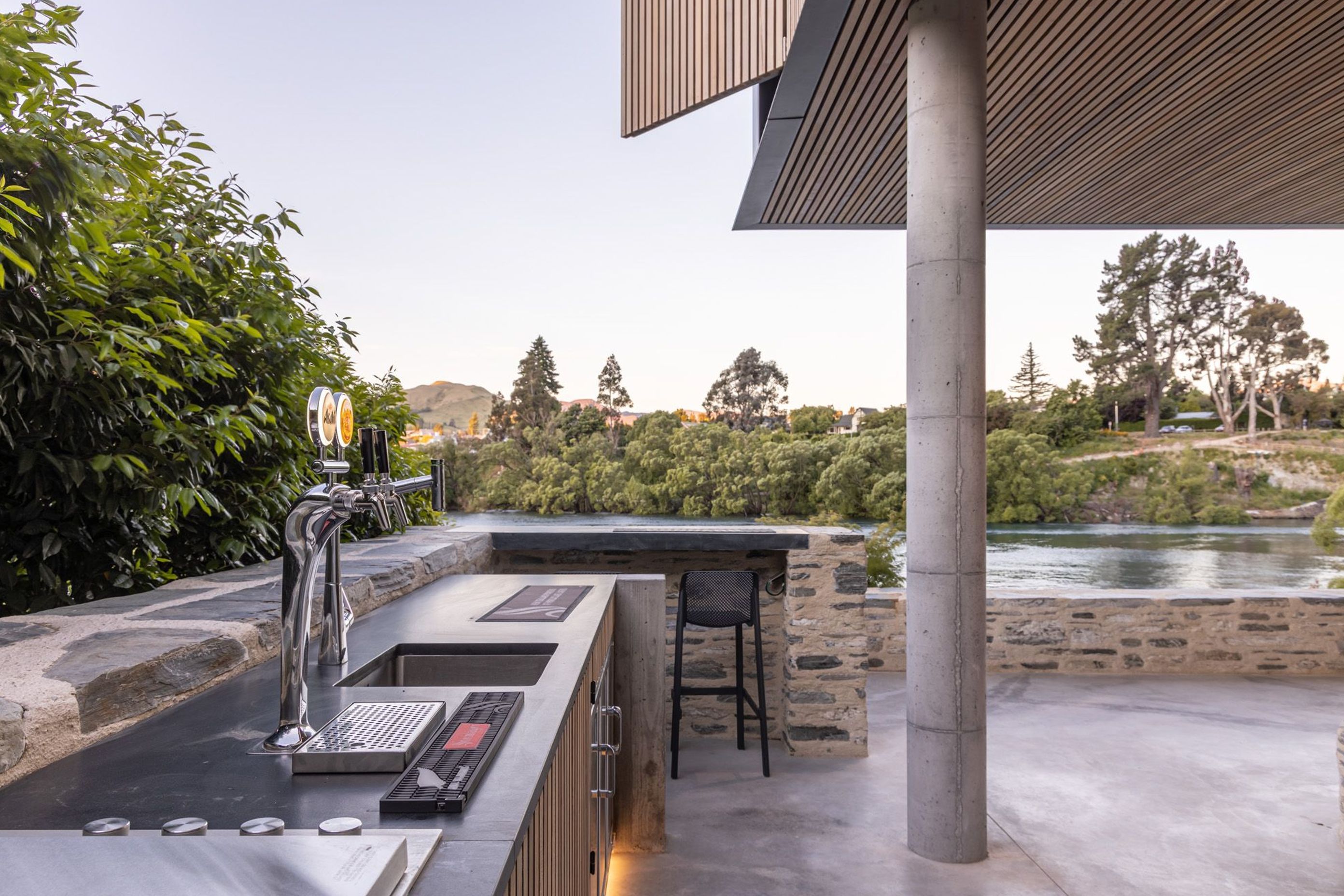 An enclosed bar and barbeque area stretches along one wall of the outdoor room and features two beers on tap!