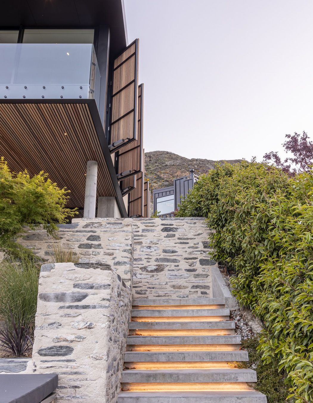 The underlit schist stairs from the spa pool up to the outdoor room.