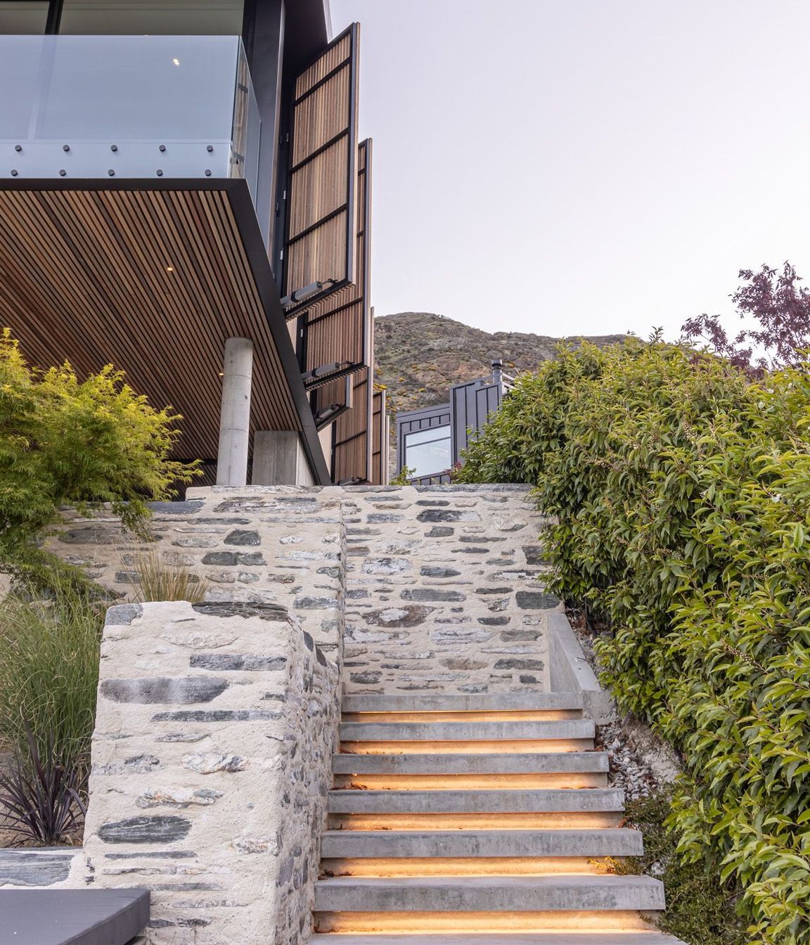 The underlit schist stairs from the spa pool up to the outdoor room.
