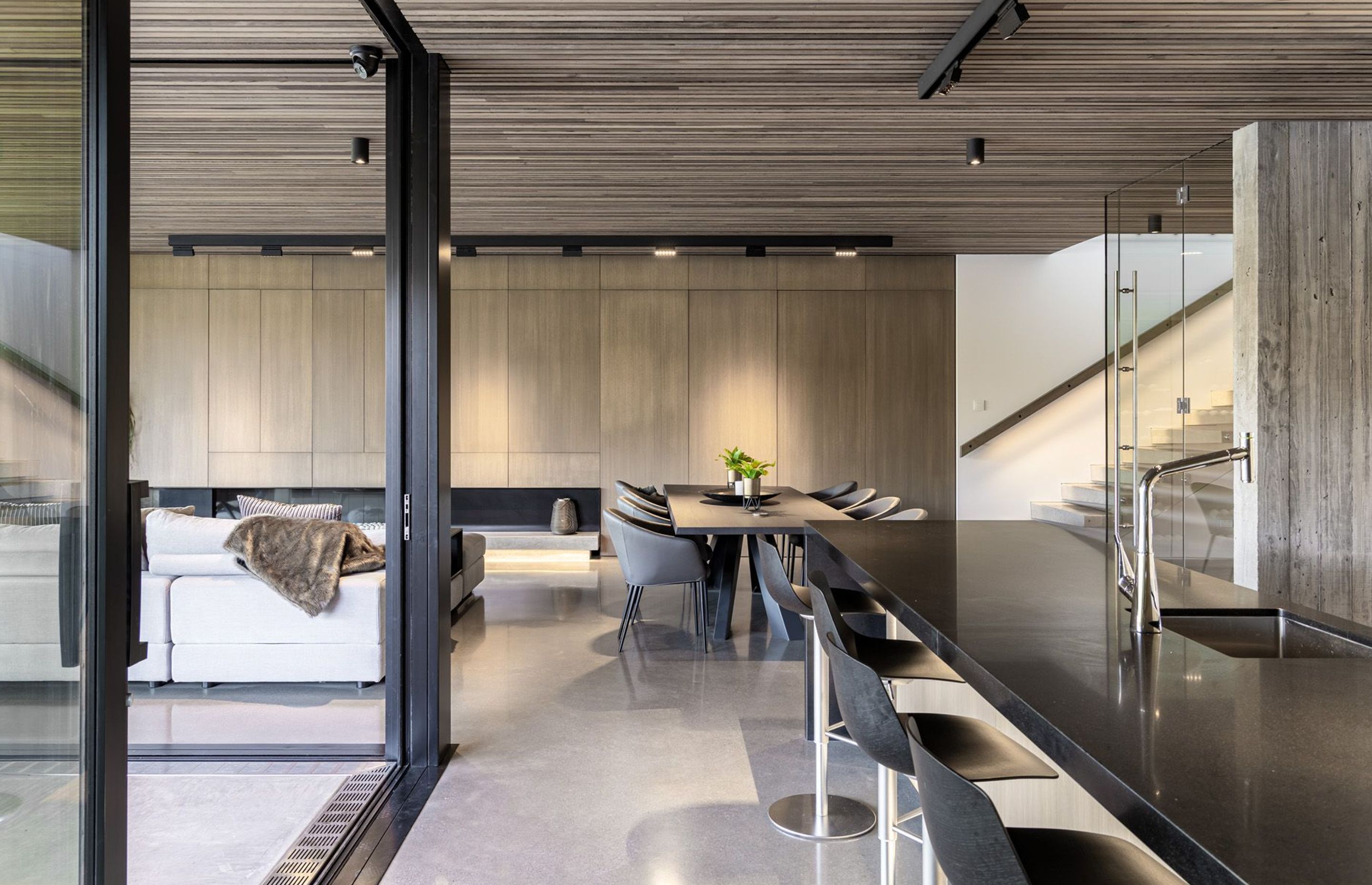 Looking from the kitchen to the dining area and the bottom of the staircase.