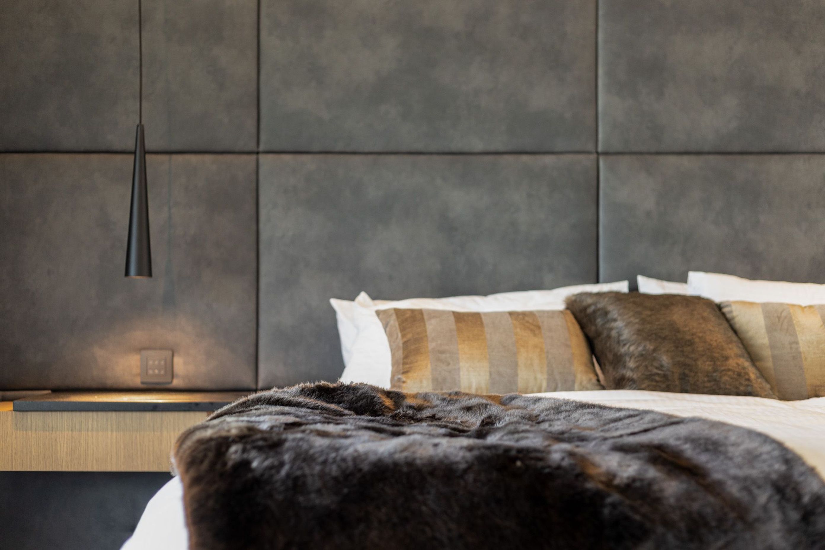 The luxe bedroom adopts neutral colours placed tone on tone with plenty of different textures.