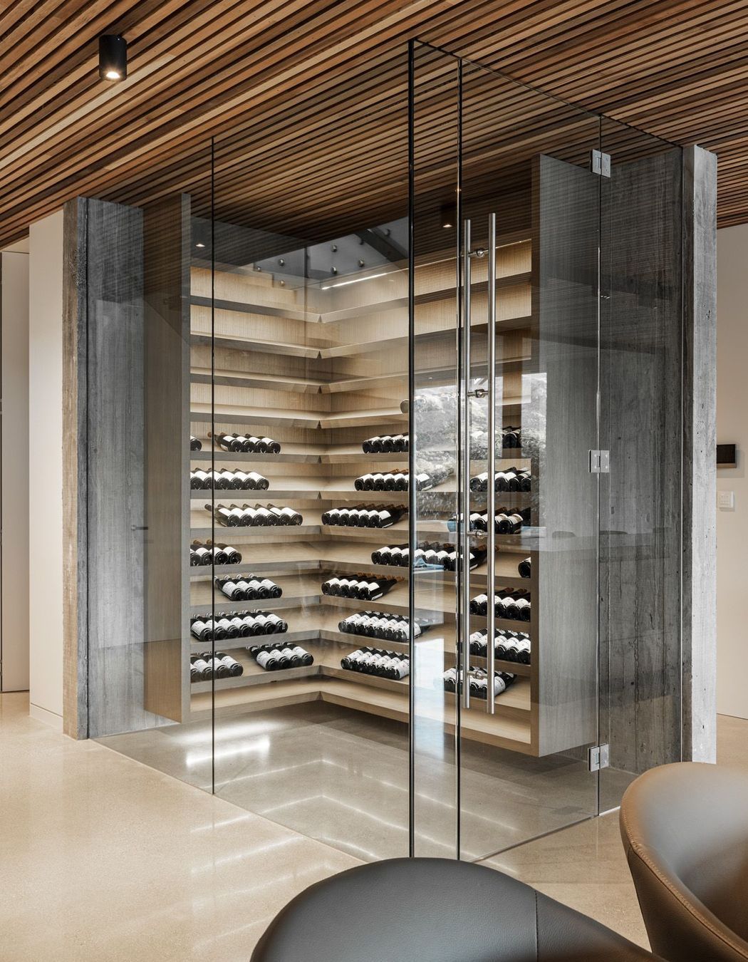 The wine cellar is a contemporary climatically controlled glass box.