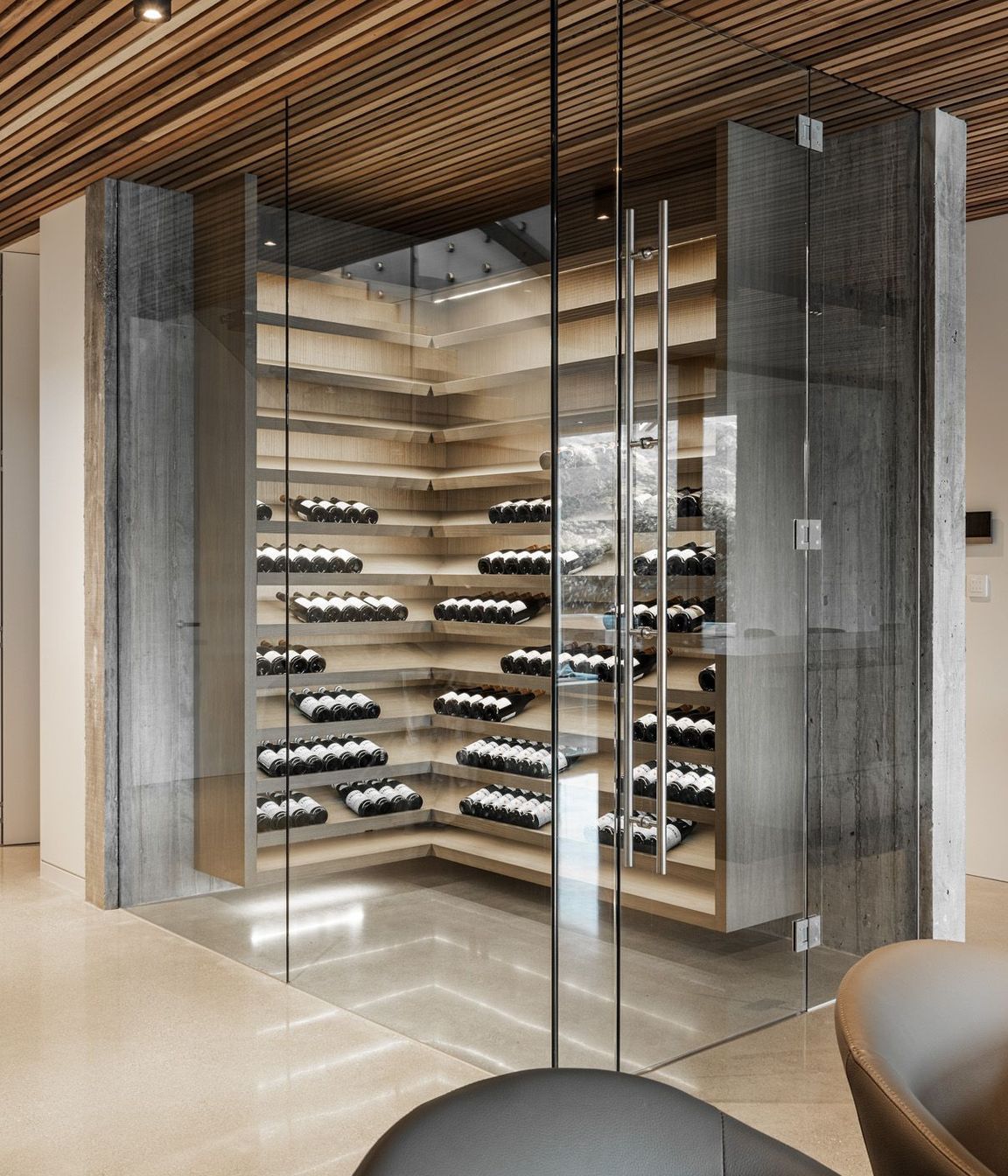 The wine cellar is a contemporary climatically controlled glass box.