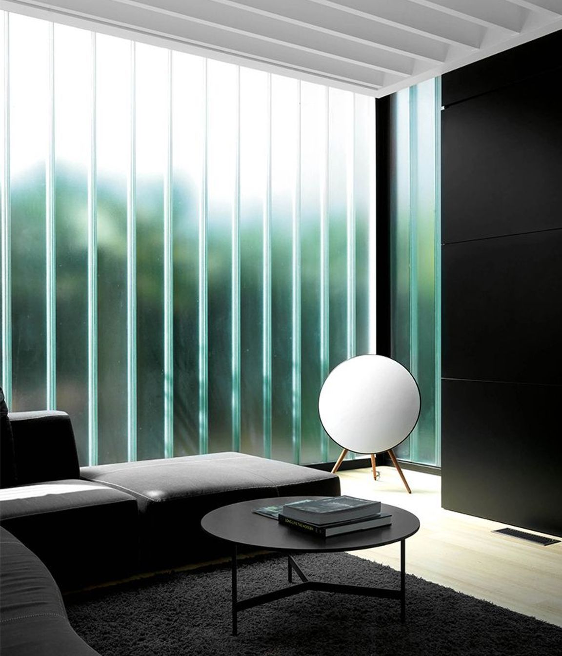 The glass wall admits soft light while providing privacy from neighbours.