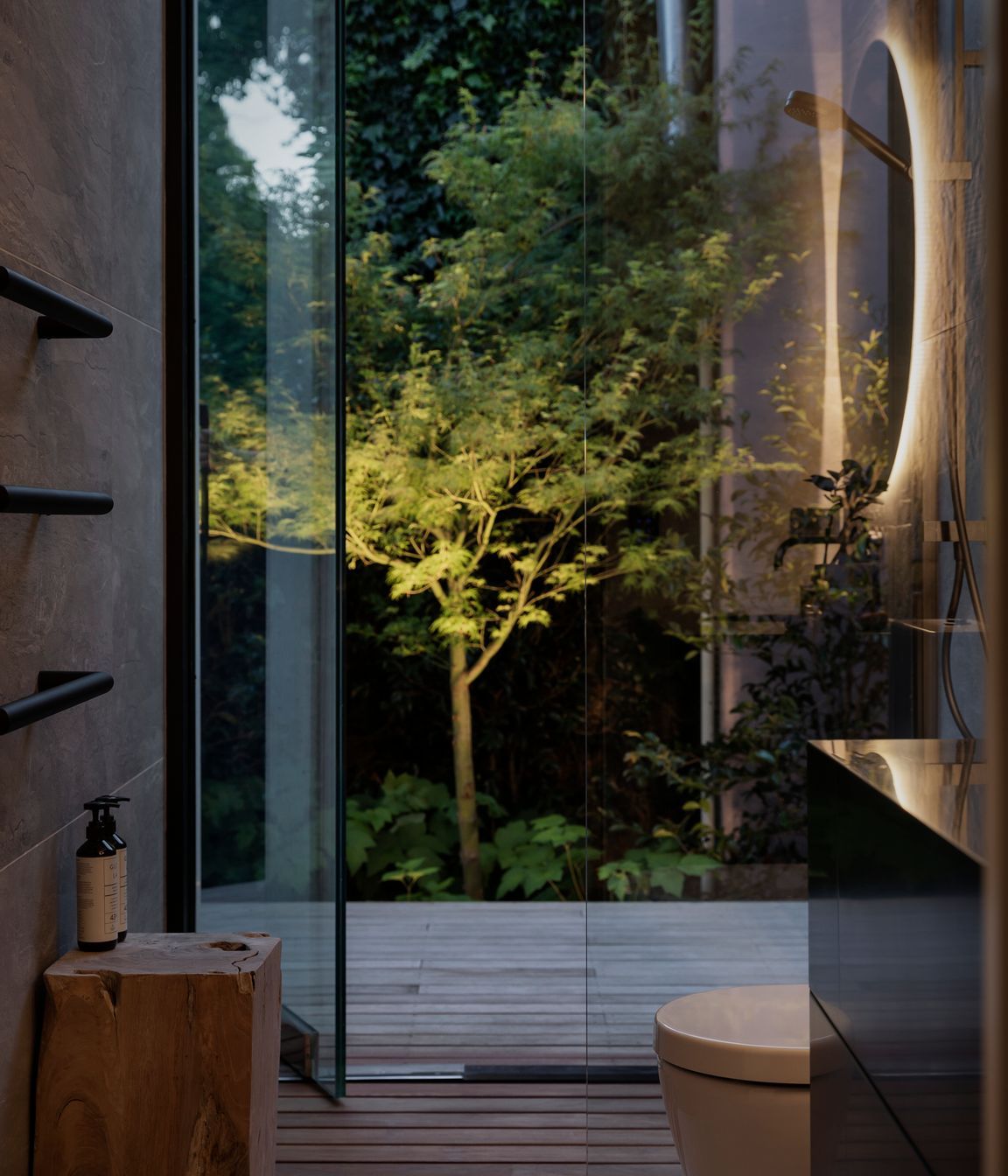 A maple tree in the adjacent bathroom forms a  sculptural form lit up at night.
