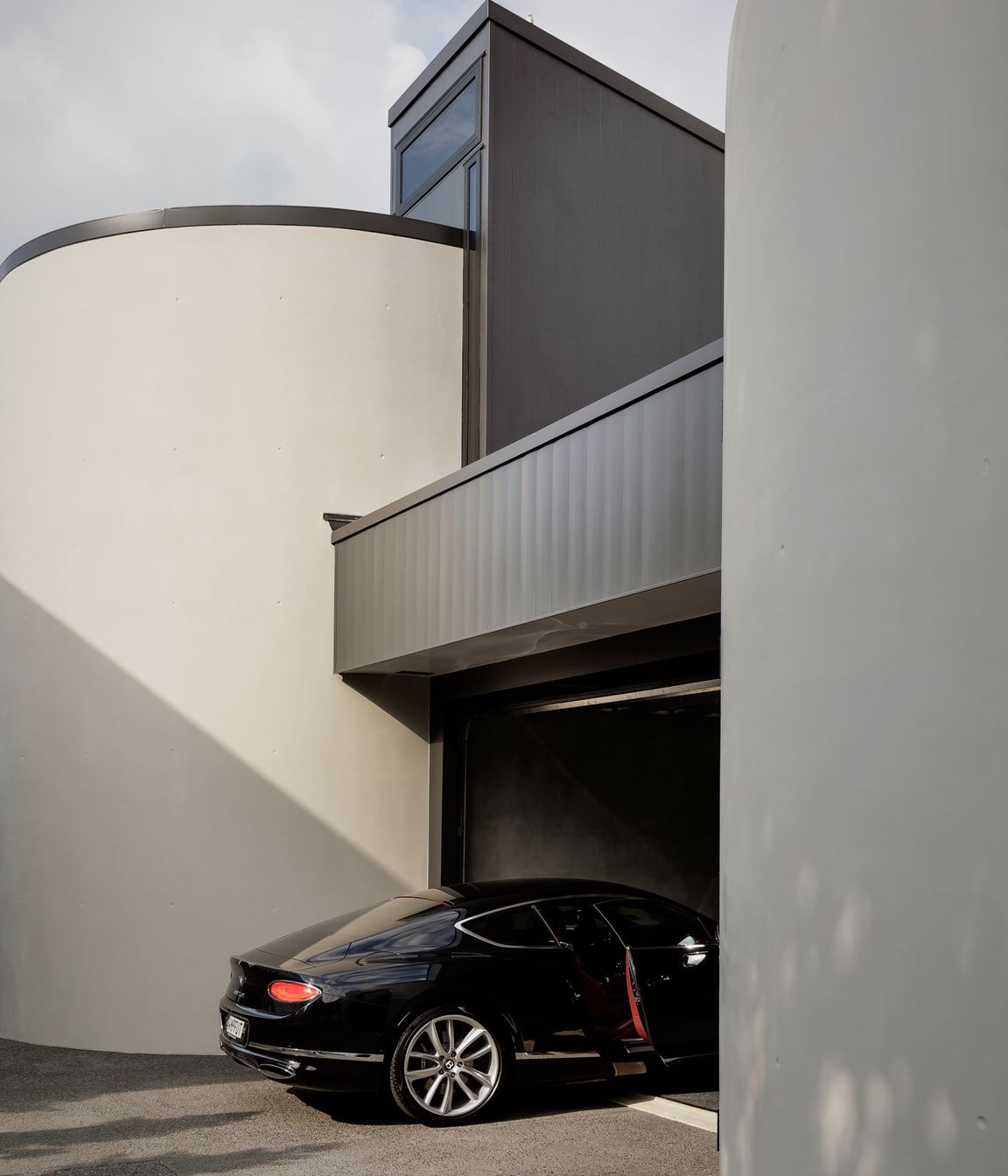 Curved insitu concrete walls either side of the garage provide ample turning space.