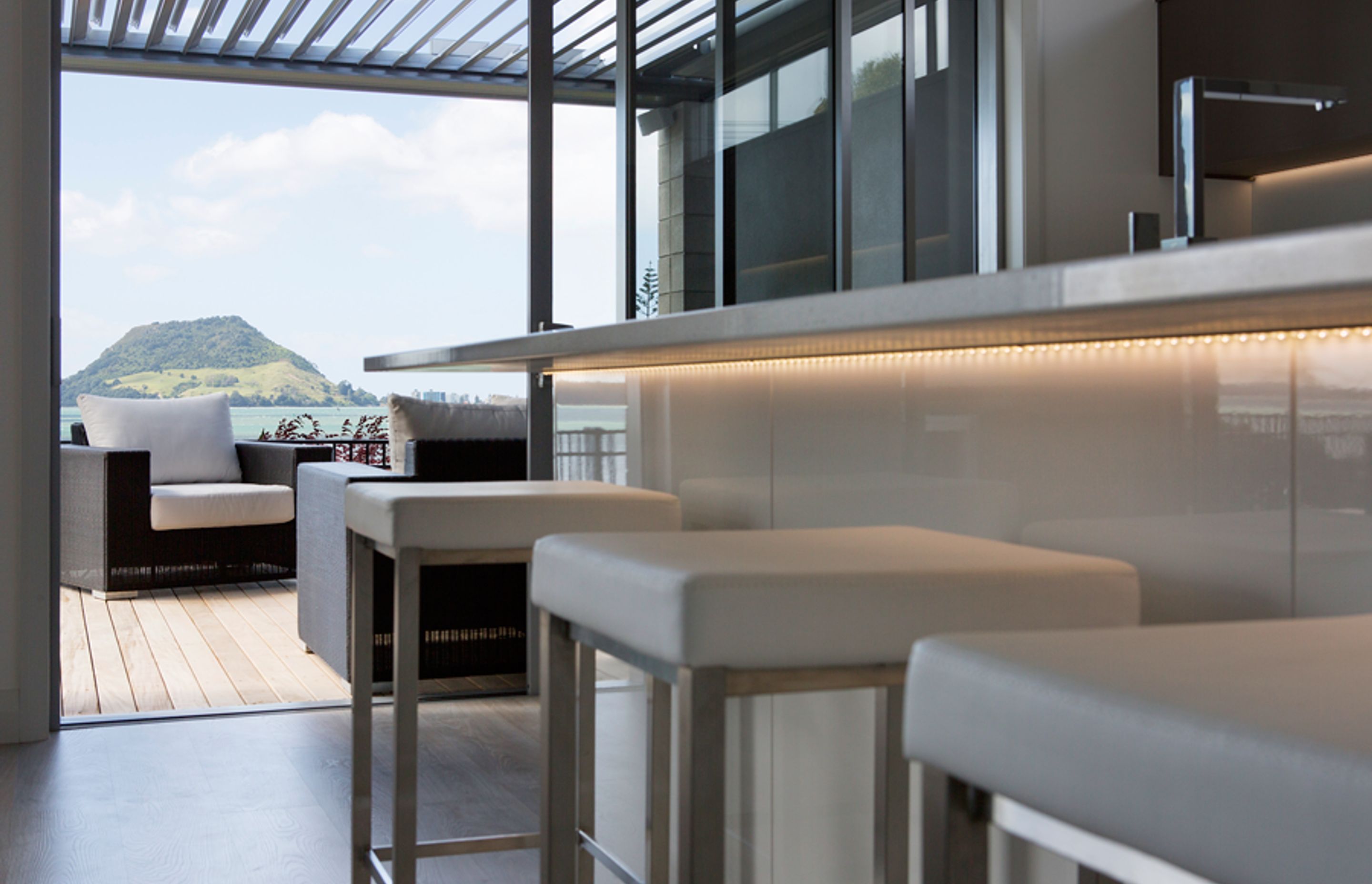 and a high gloss lacquered kitchen with stone tops make this space incredible.