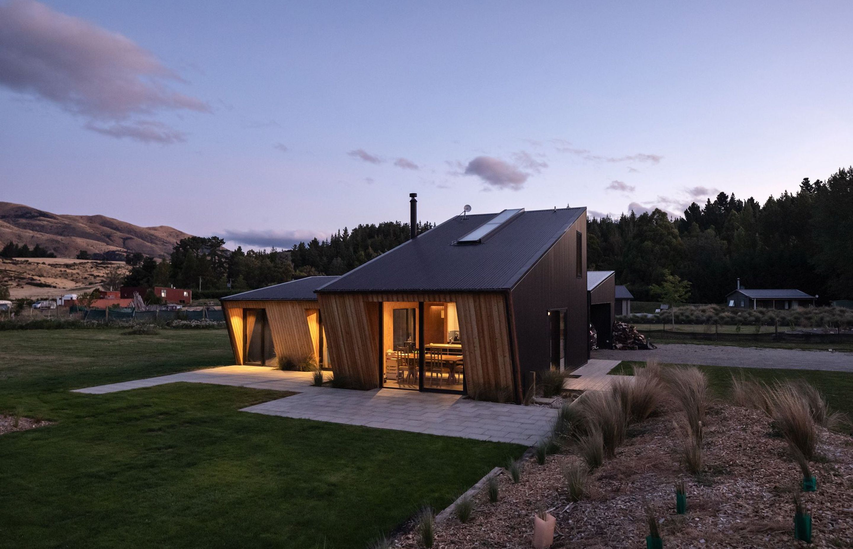 The elevations that lean forward into the prevailing wind are accentuated with vertical larch cladding.