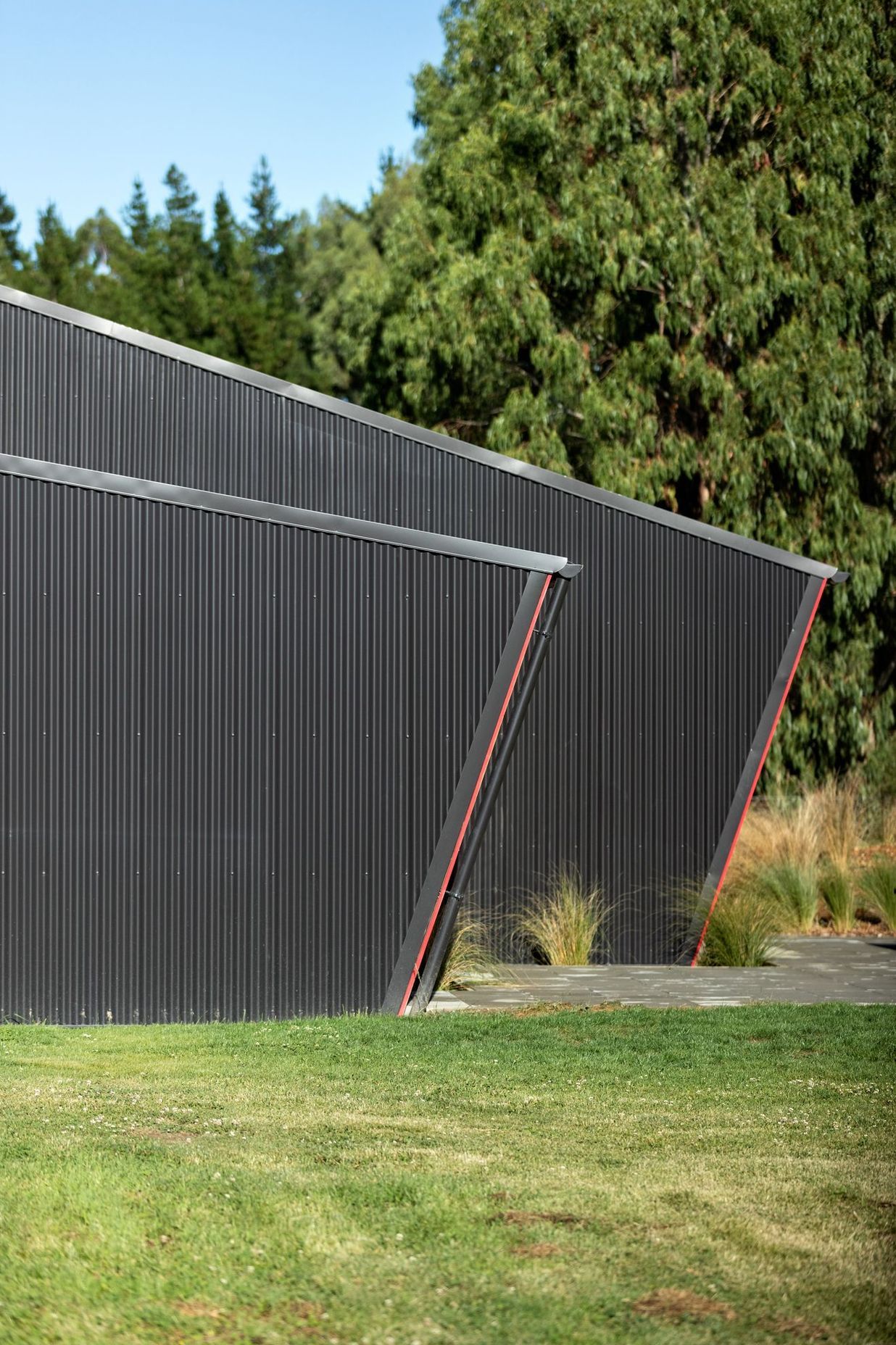 The simple angular forms take cues from agricultural buildings that often have a strong, easily understandable geometry.