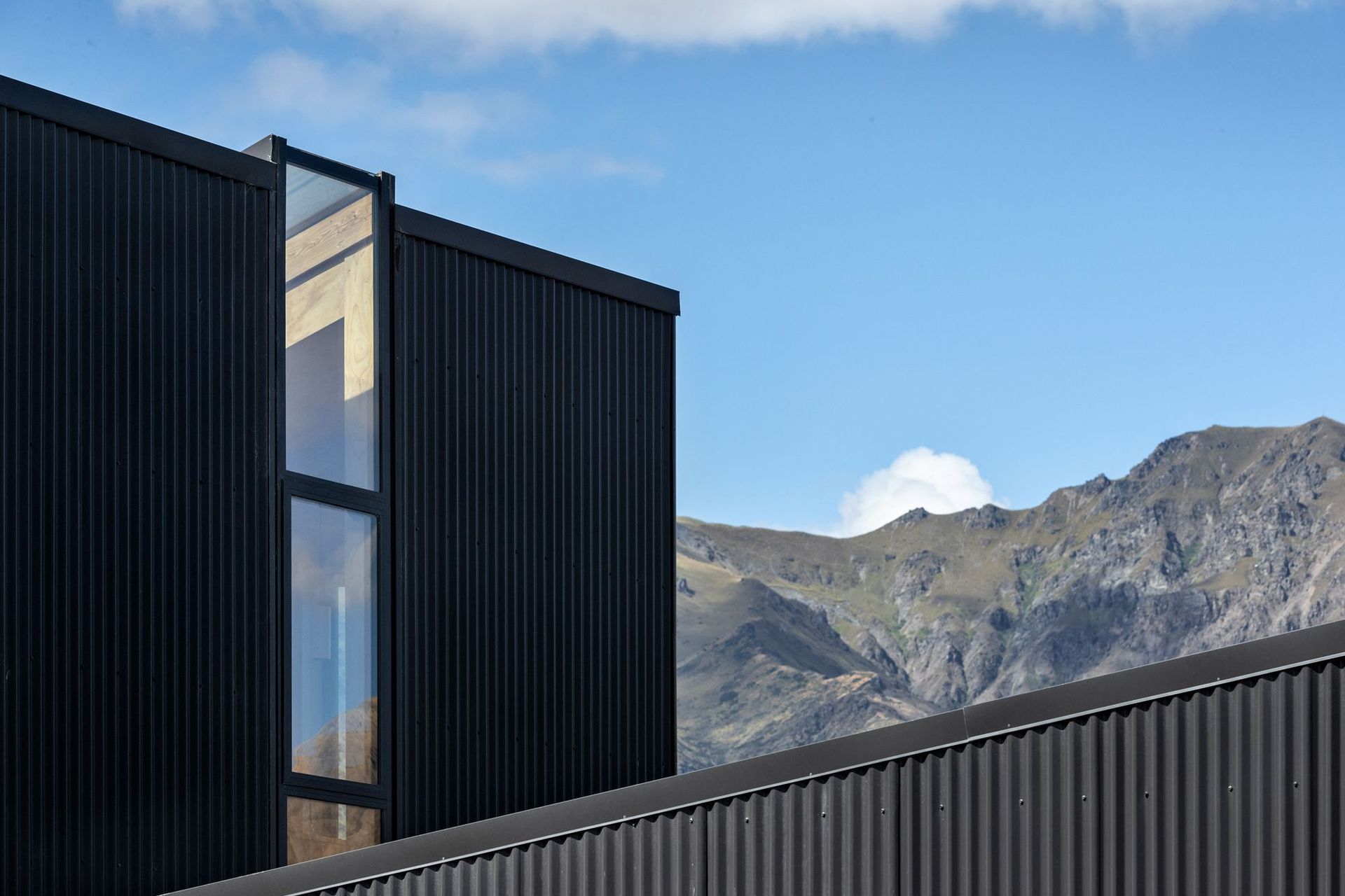 A strip window meets a skylight in the roof to draw the light into the mezzanine bedroom and stairwell. 