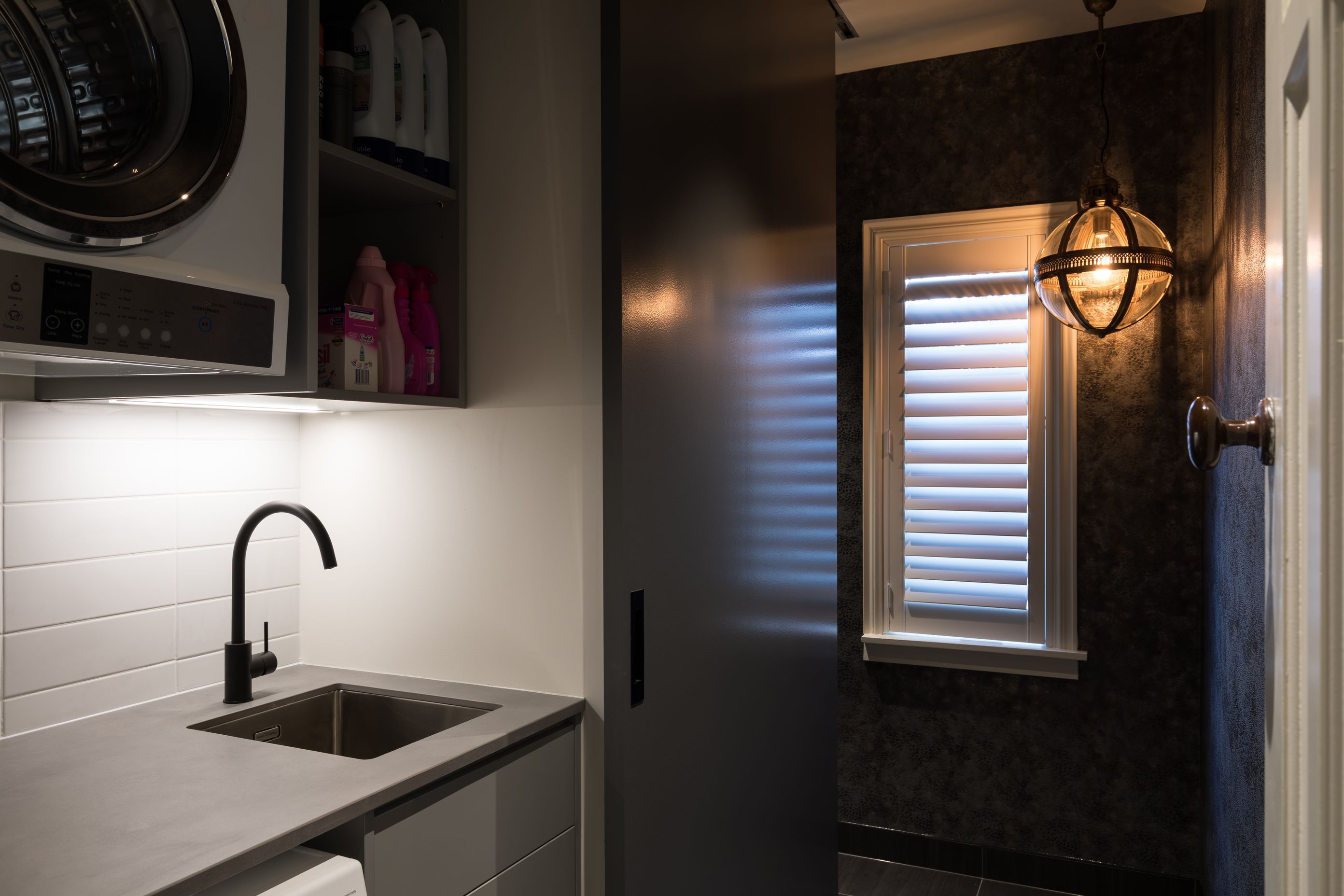 Combined Laundry and Powder Room - Laundry hidden behind large sliding door, with track inset into the ceiling