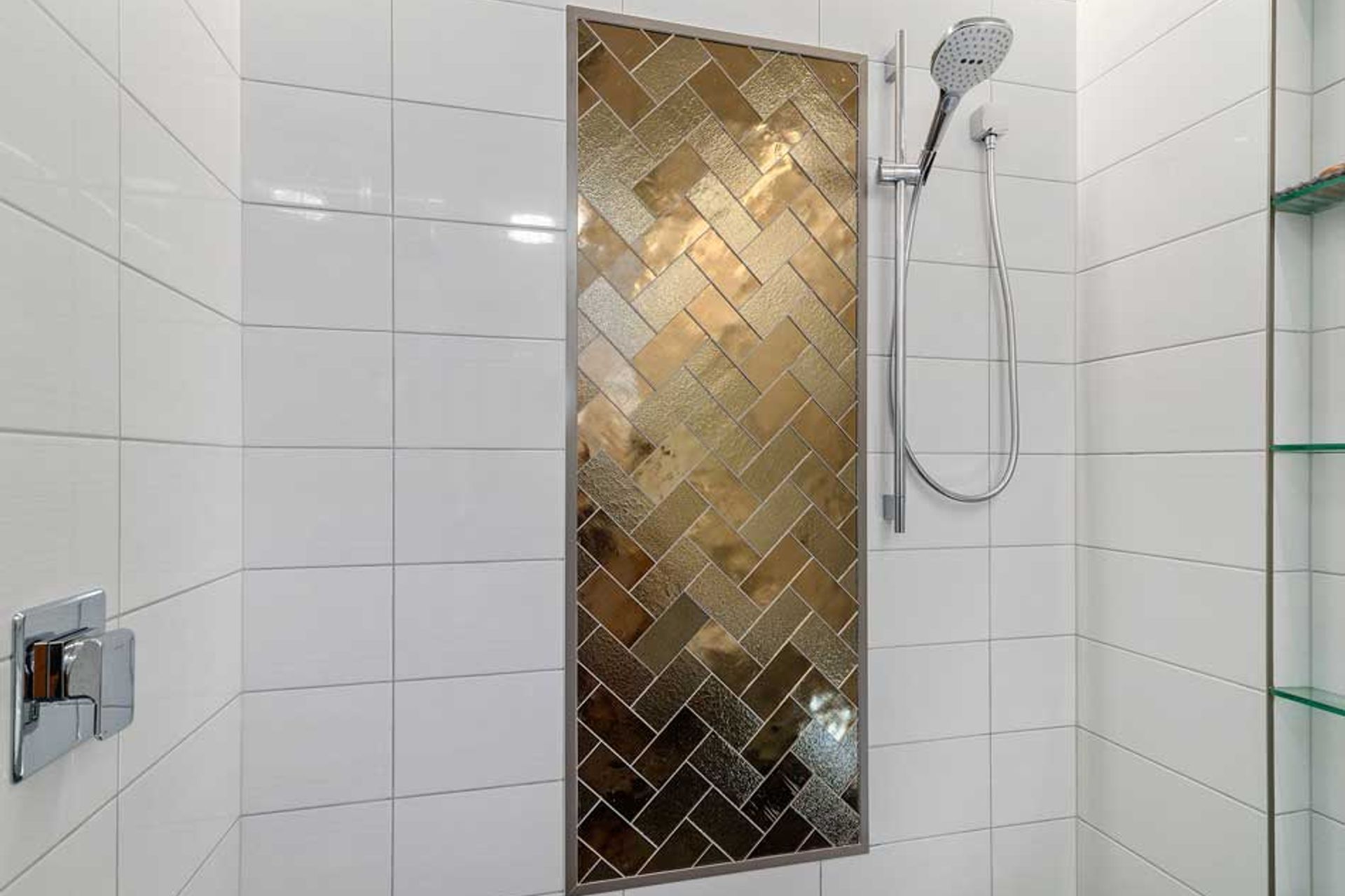 These bronze glass tiles are definitely a feature inside this double shower - and the herringbone pattern adds interest