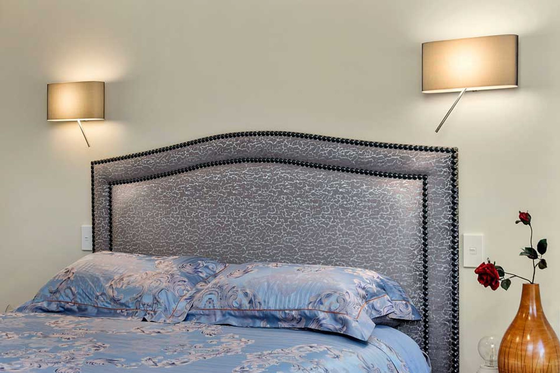 These wall lights are such a clever design. There is a LED lamp inside the shade and another at the end of the wand - you can switch them to have both on at the same time, or just one. This lets someone read and the other person sleep without blinding li