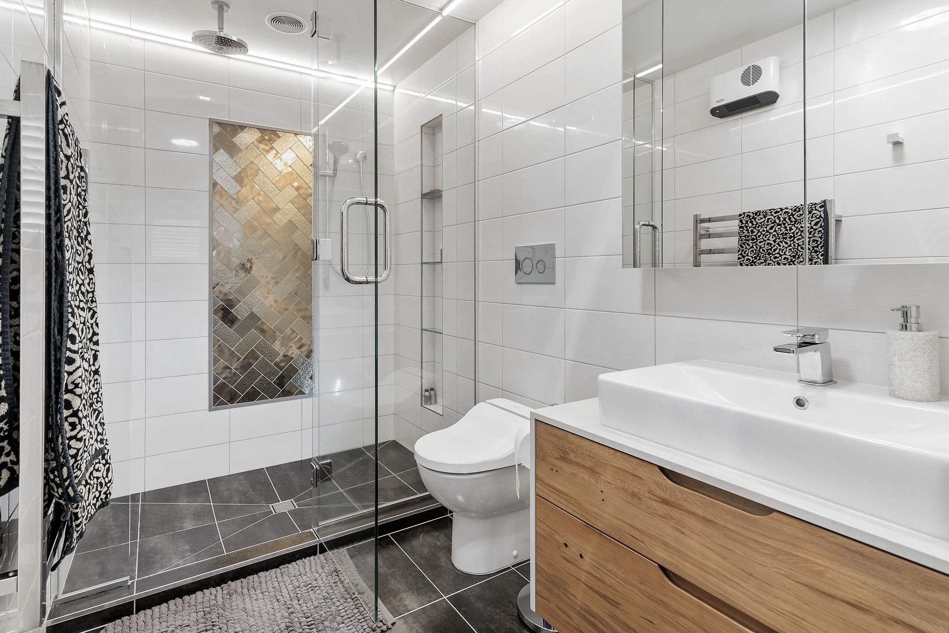 Ensuite bathroom with double shower, custom vanity, mirror storage and bidet. This gorgeous vanity with caesarstone top and solid timber drawers in addition to the mirror cabinet offers great storage solutions