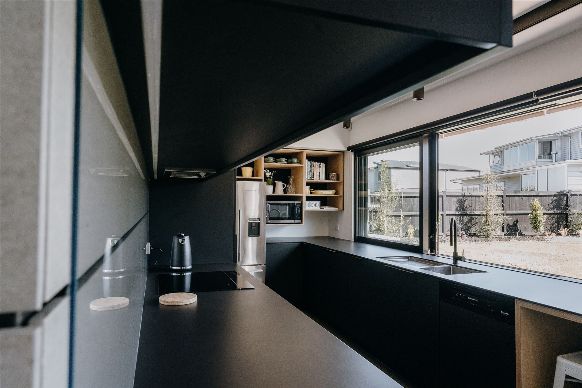 Matte black and timber are the central features in the kitchen, creating a consistent aesthetic in line with the other areas of the home.