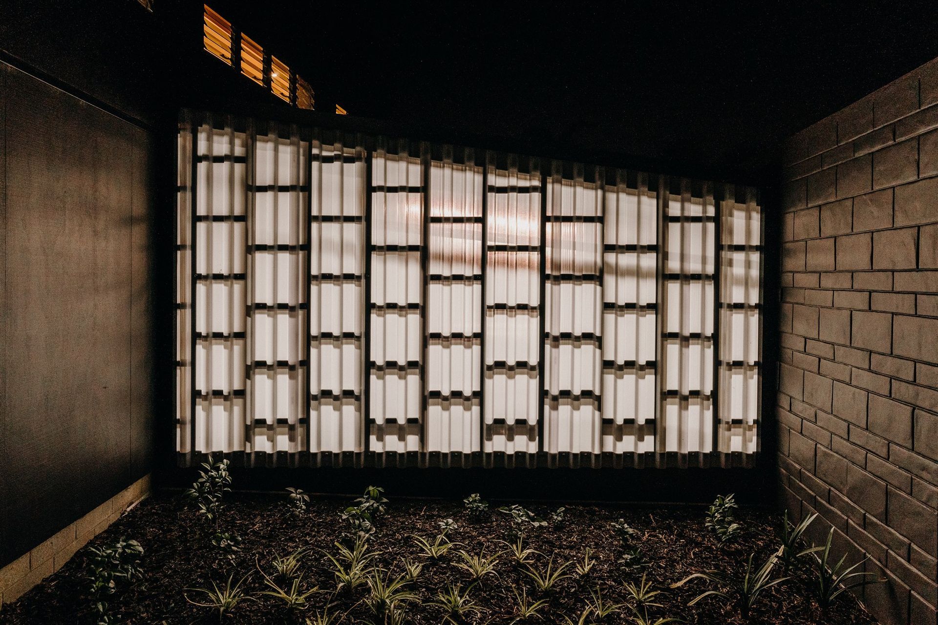 A translucent panel allows for the entrance area to be illuminated at night by the internal garage lighting.