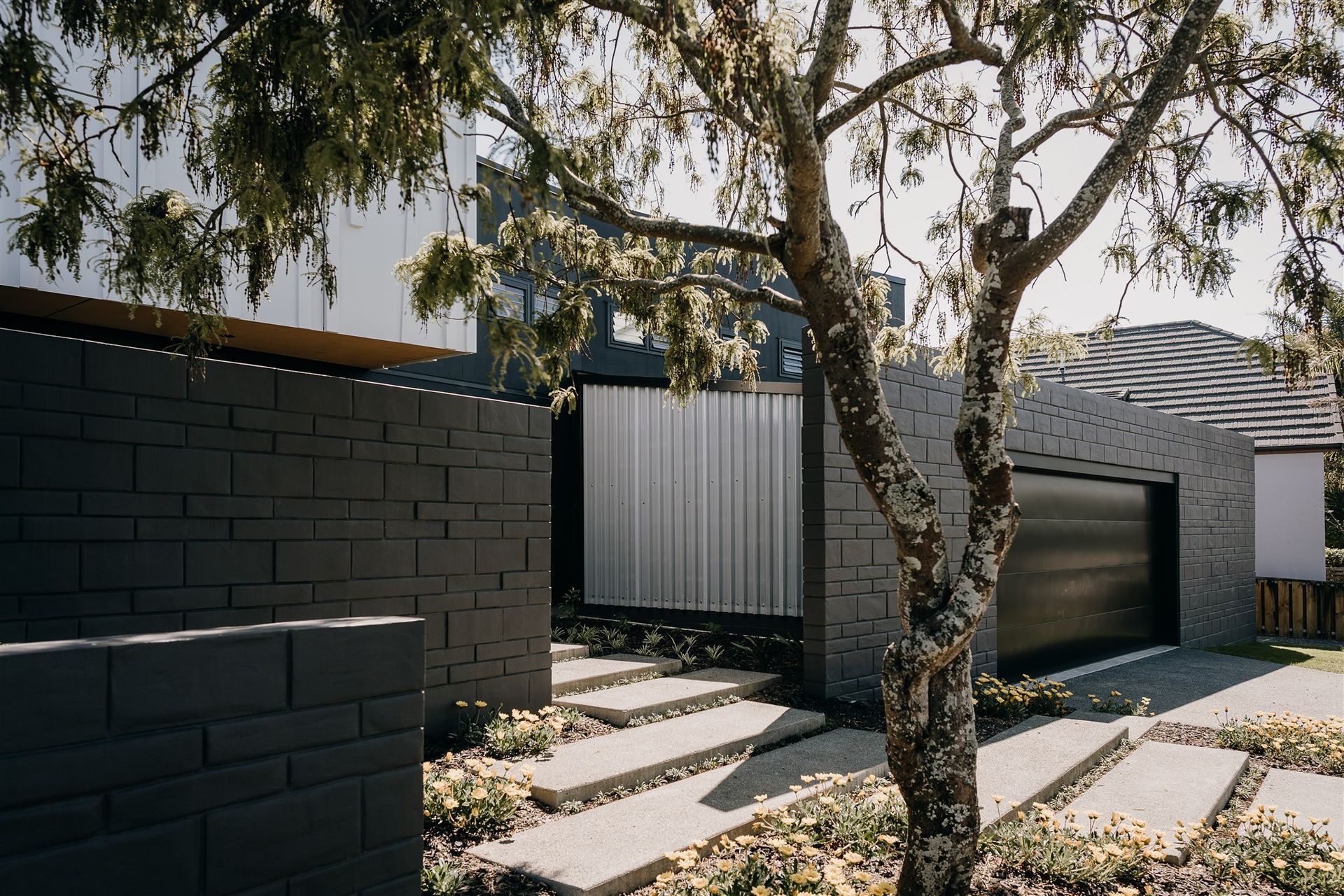 A translucent panel forms the side of the garage, designed so the internal garage lighting can double as entrance area lighting.