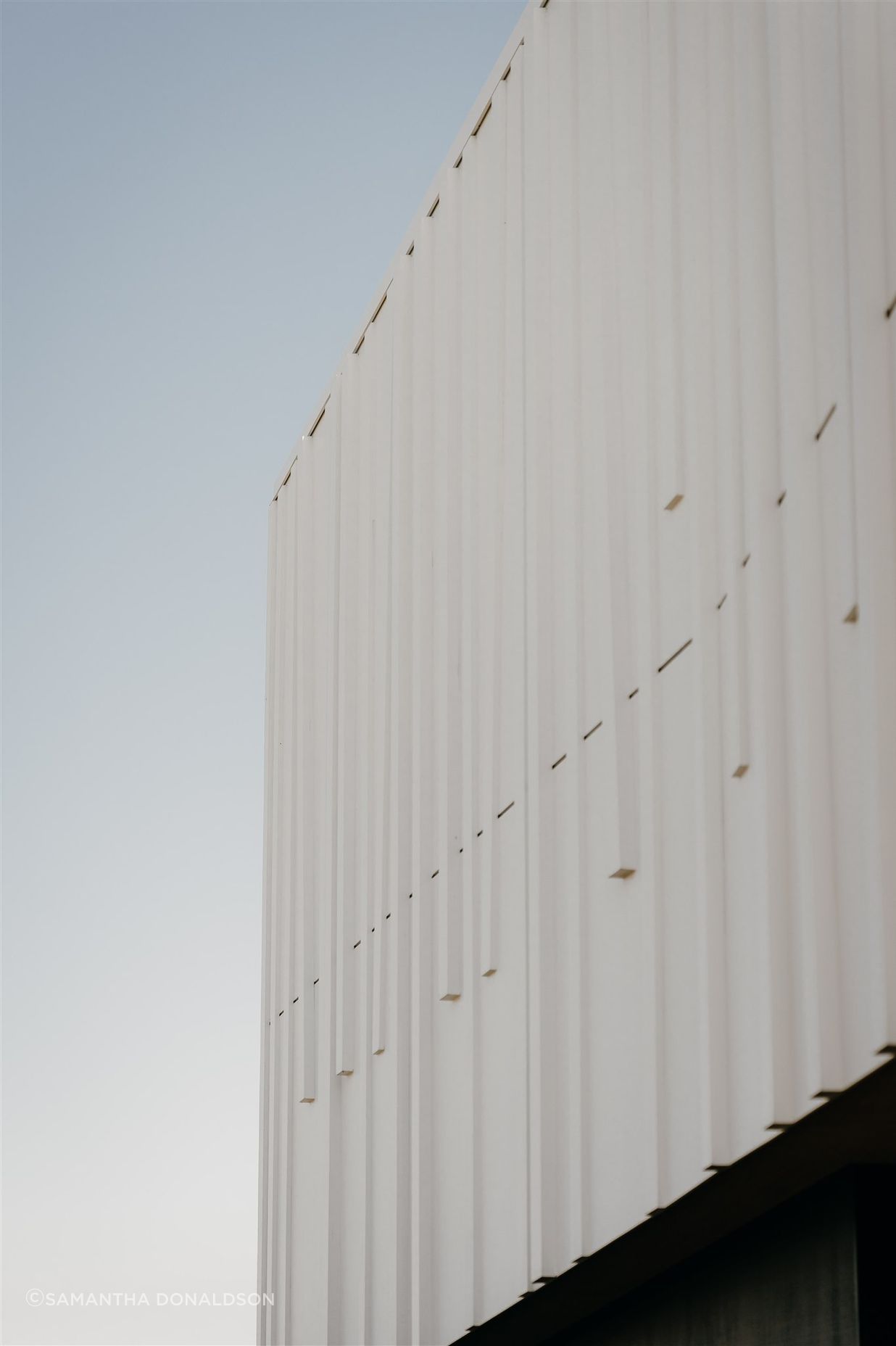 Fluted batons at different angles appear almost as if a piece of fabric had been dropped over the form from a height and created these flutes, almost like curtains