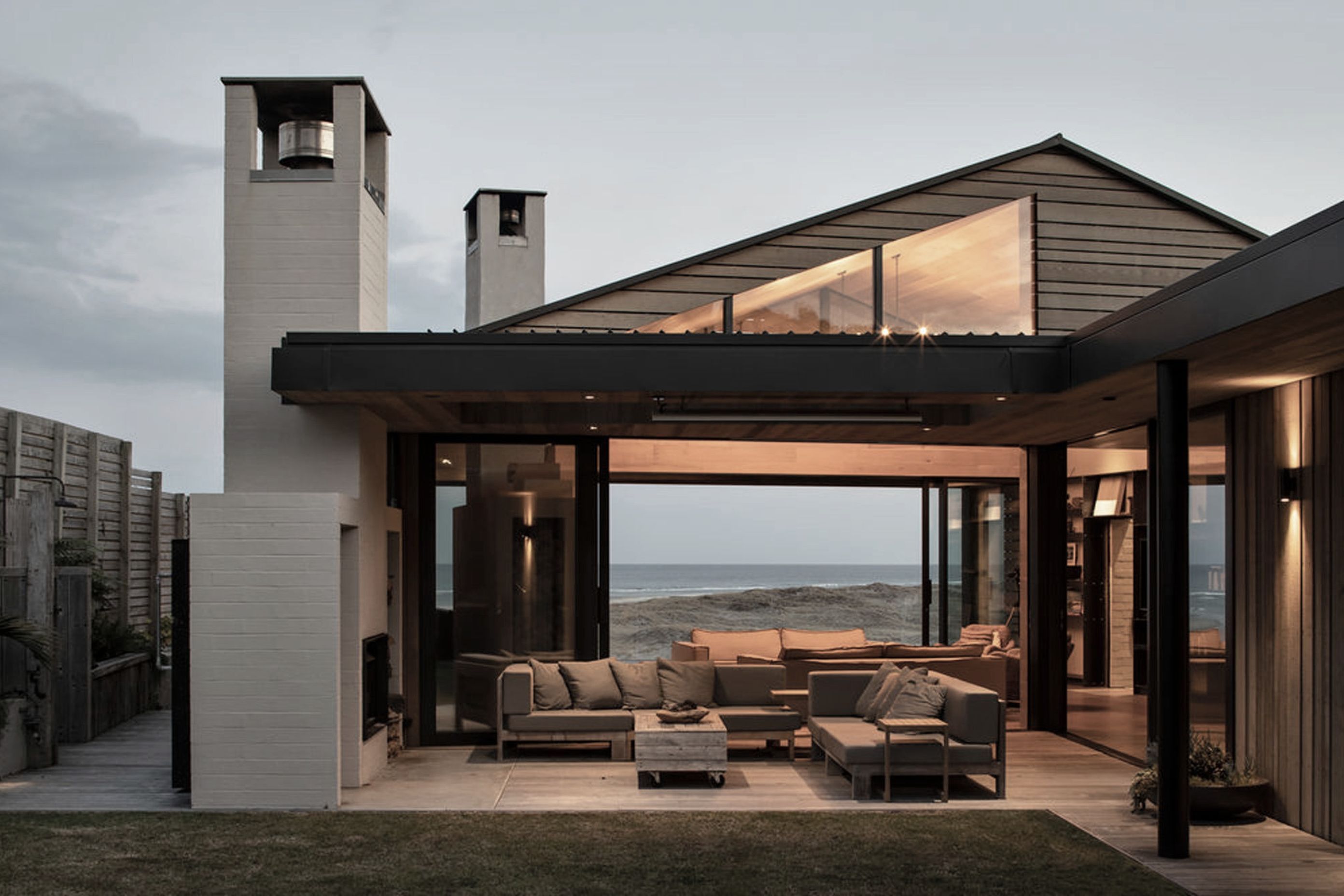A fireplace and barbecue are nestled under a sheltered terrace and take pride of place at night, while the views out towards the water command attention during the daylight hours