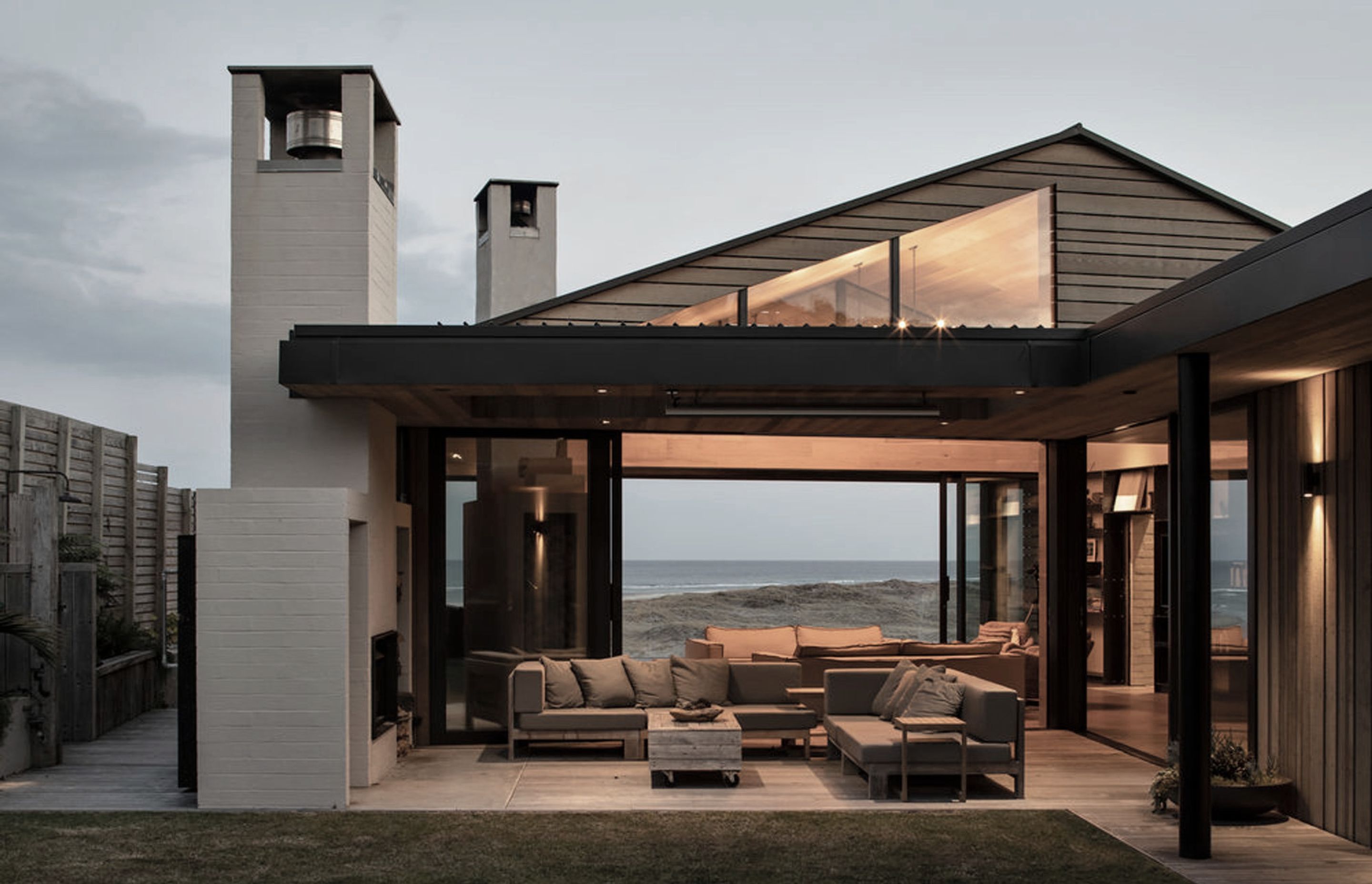 A fireplace and barbecue are nestled under a sheltered terrace and take pride of place at night, while the views out towards the water command attention during the daylight hours