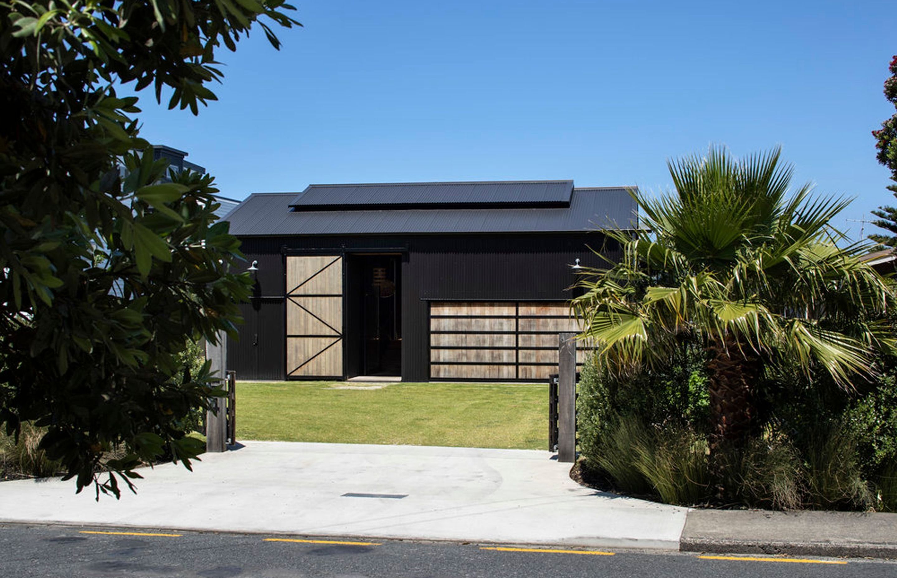 From the road, the house reads as an understated, corrugated-clad shed.