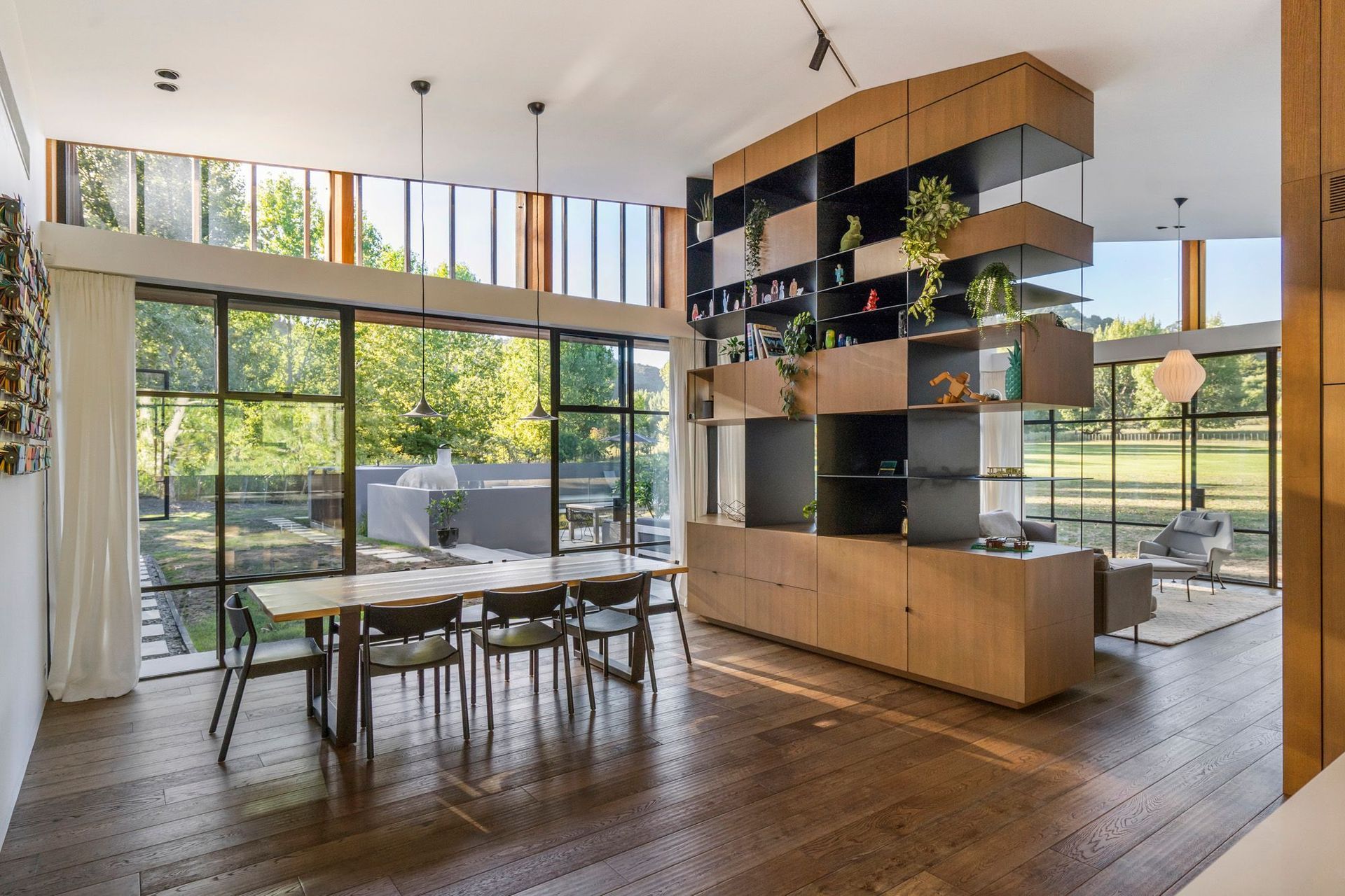 A huge floor-to-ceiling room divider in timber and steel is a key feature of the open-plan dining and lounge area.