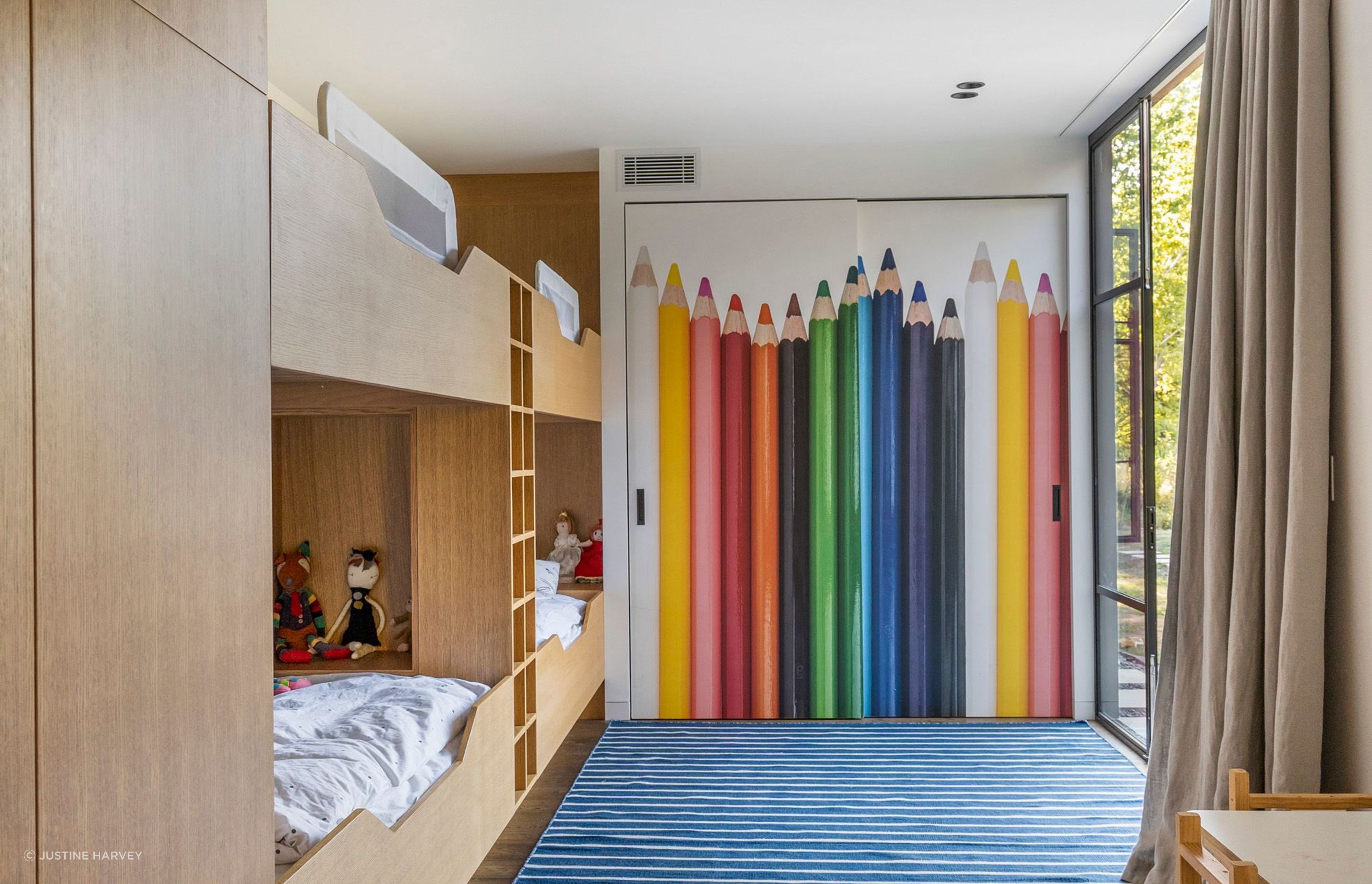 The playroom/bunkroom leads into the main hallway and the courtyard.