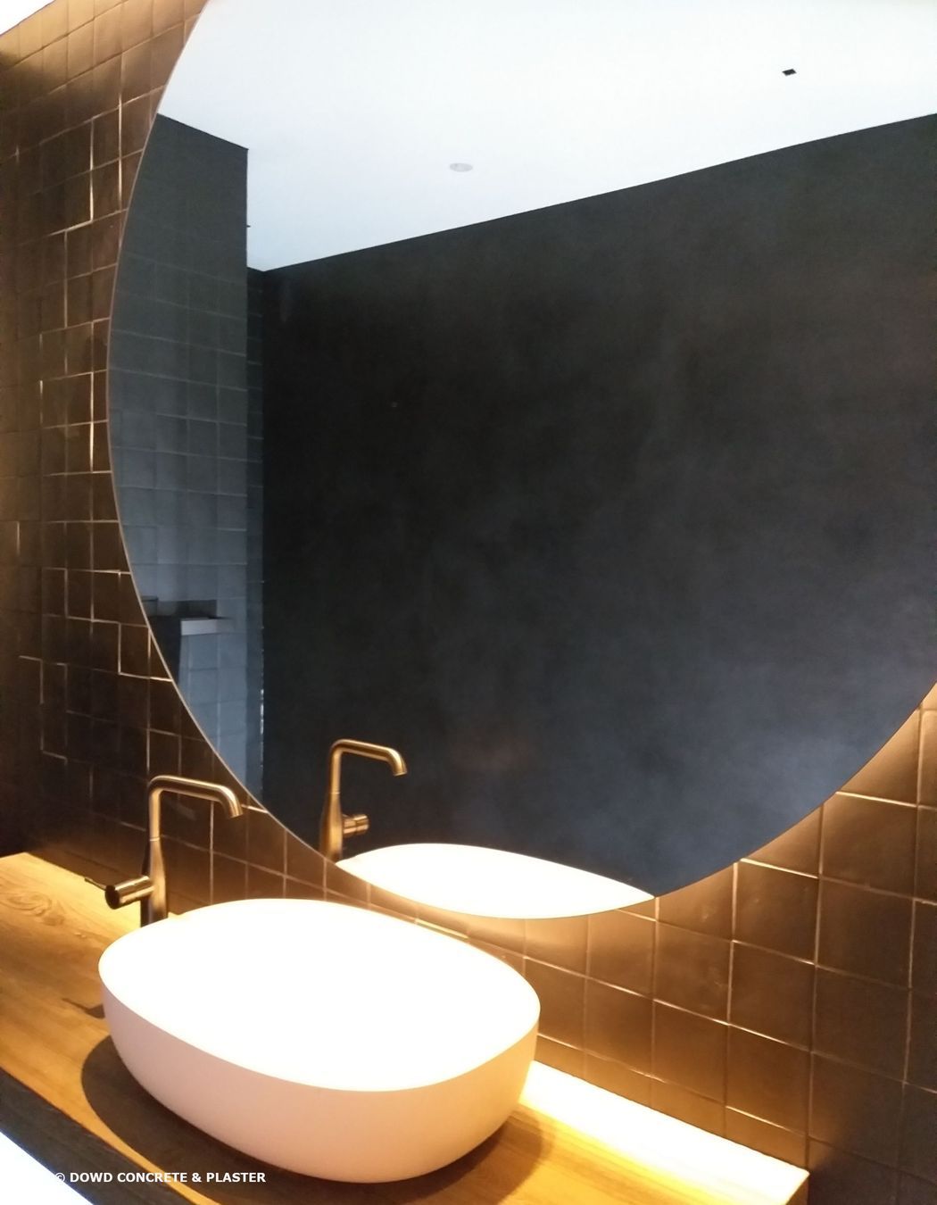 Bathroom wall finished with black Venetian plaster