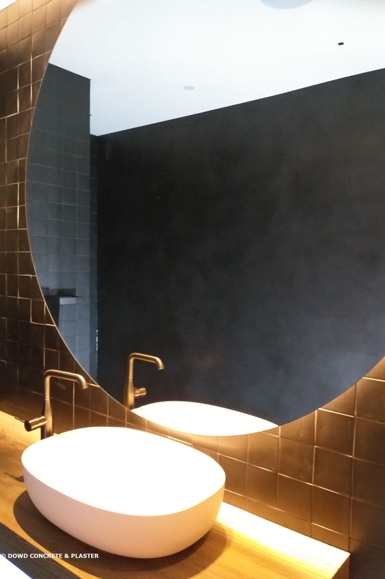 Bathroom wall finished with black Venetian plaster