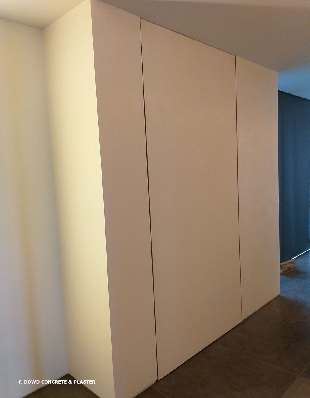 Plaster on door to hide it and create seamless finish