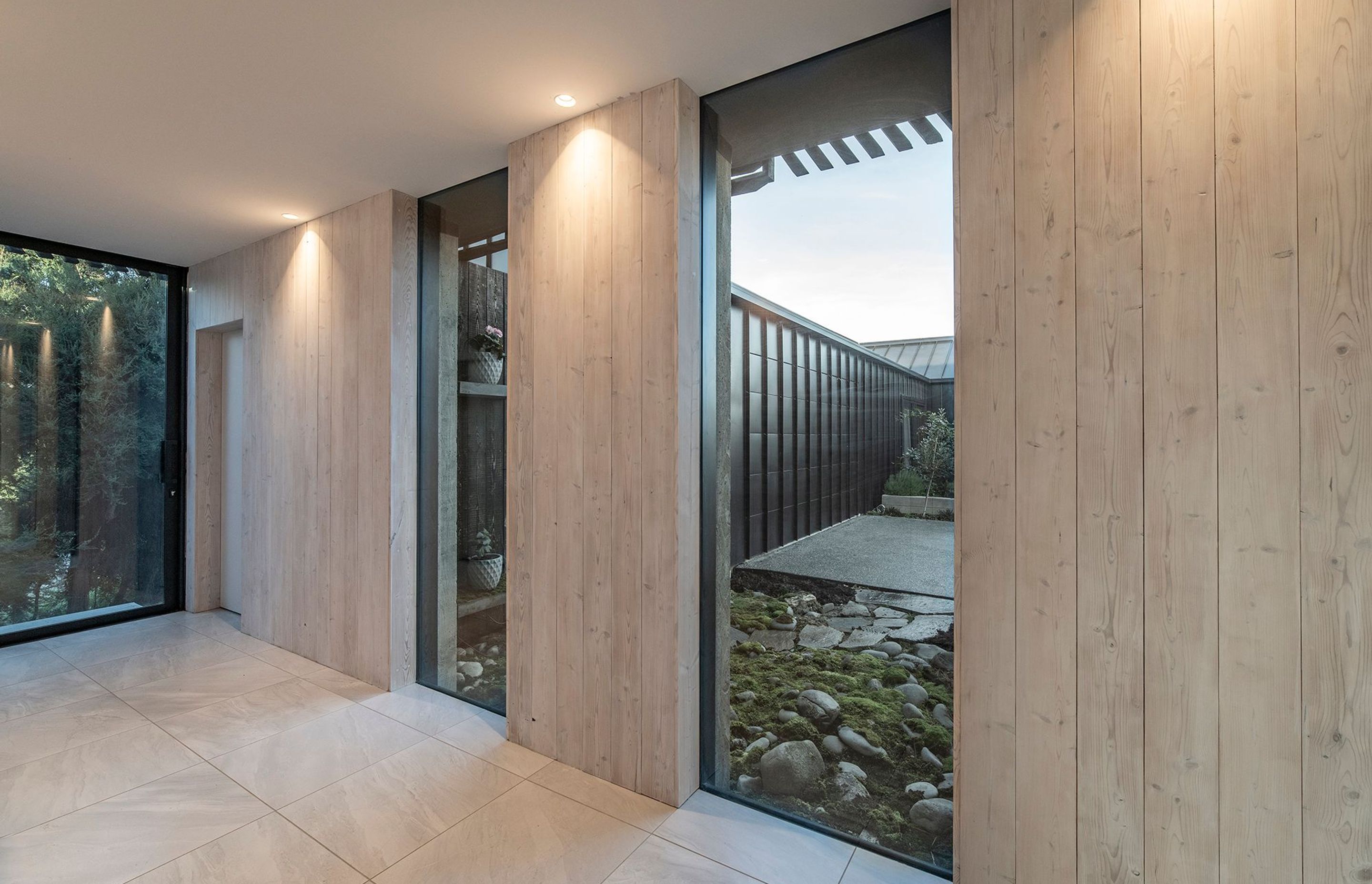 The gallery space off the hallway has a deck off the end, while glazed arches overlook a micro-landscape in the main courtyard near the entrance.