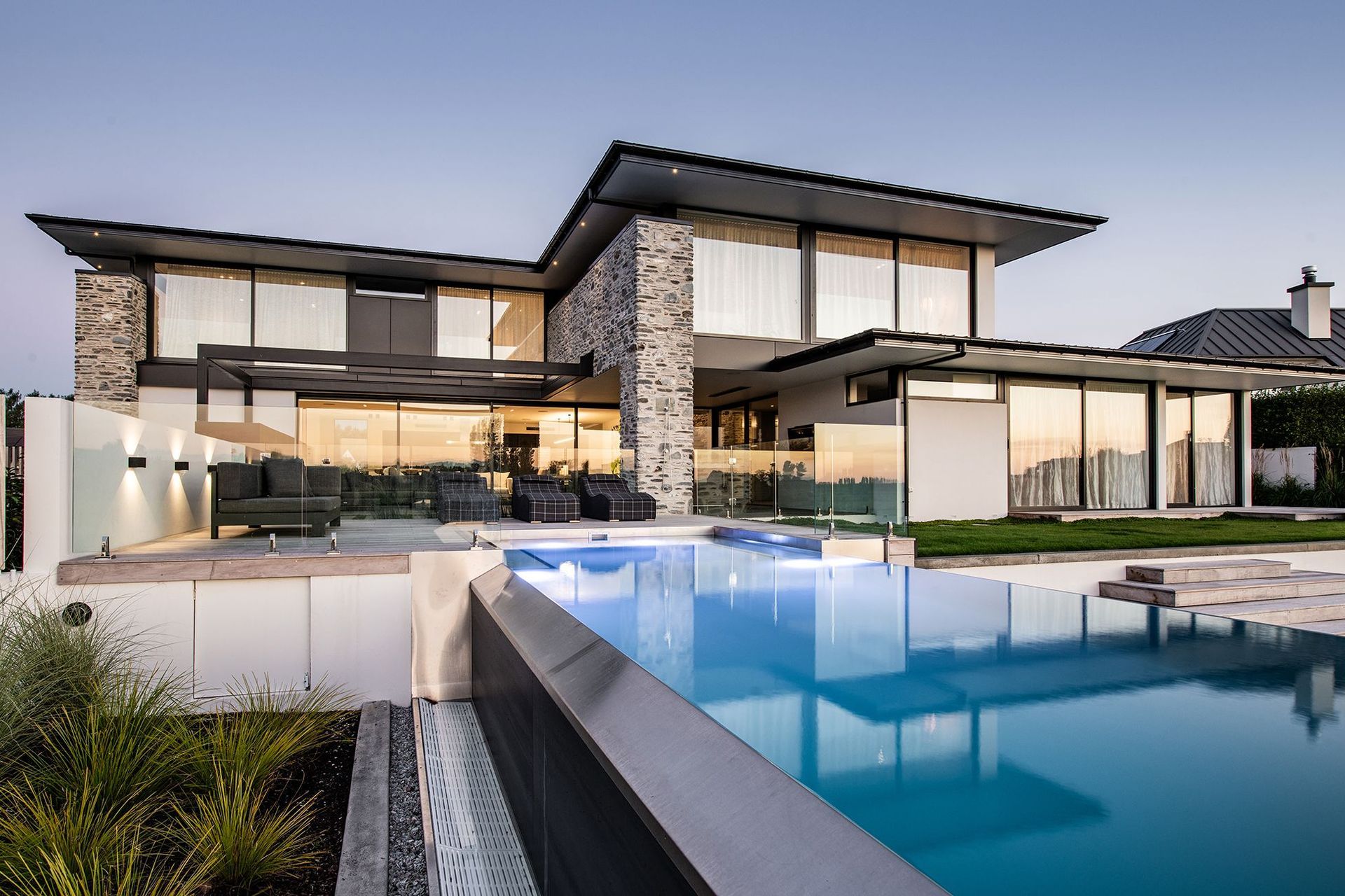 At the back of the home, the house opens up to an outdoor entertaining space, with decked swimming pool and spa pool area.