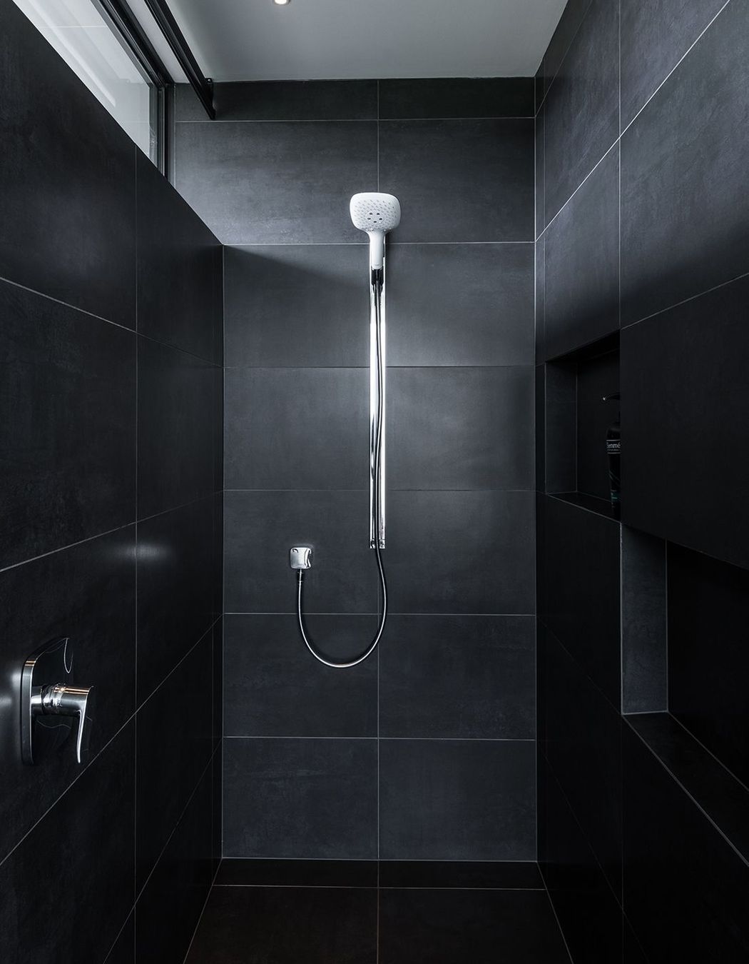 The black tiled shower area.