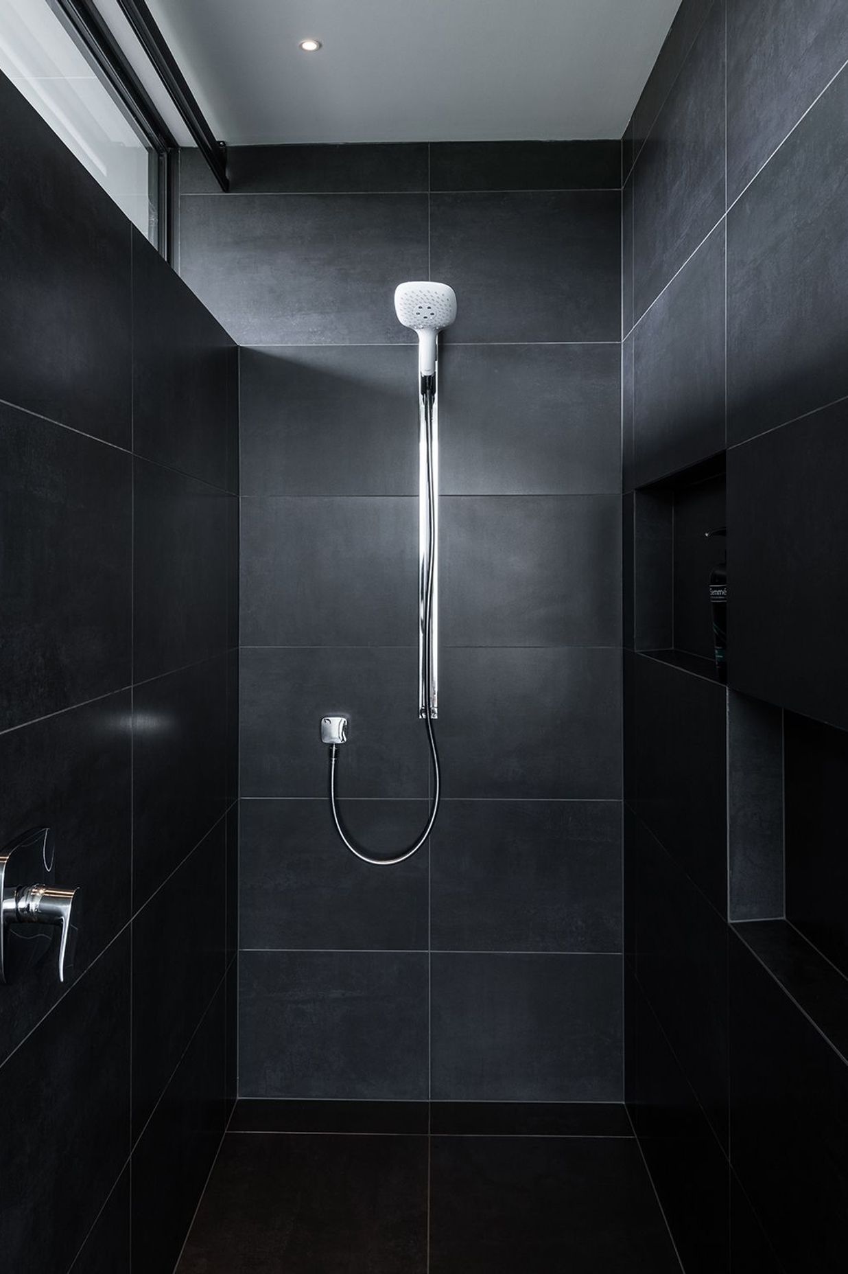 The black tiled shower area.