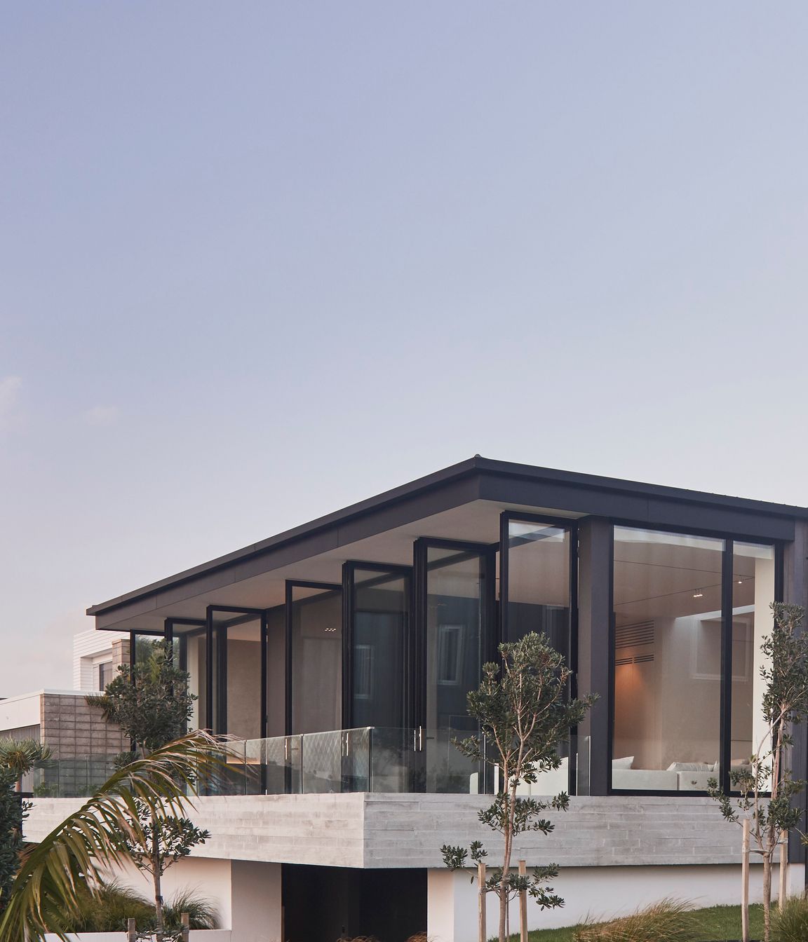 The east-facing balcony is accessed from both the lounge and main bedroom through a bank of full-height, glazed doors.