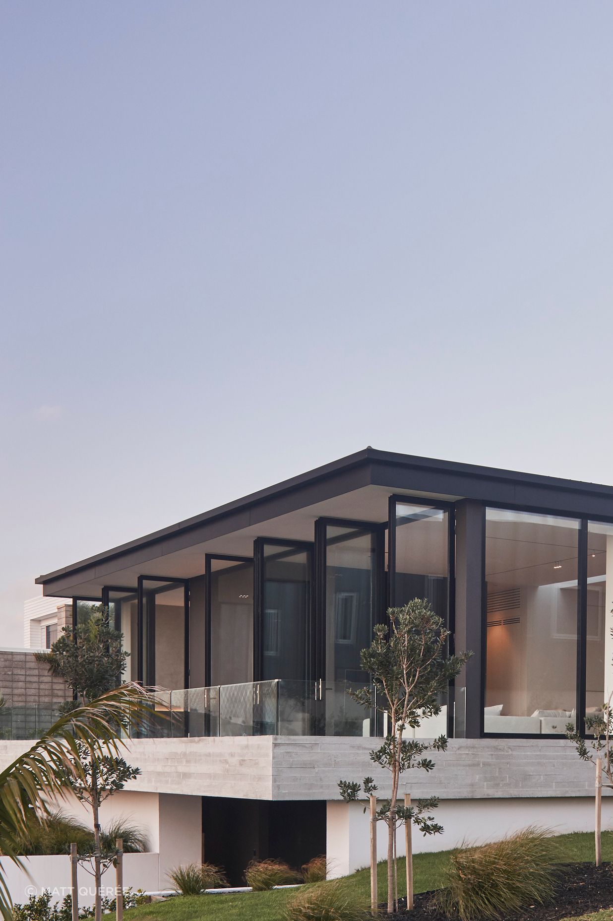 The east-facing balcony is accessed from both the lounge and main bedroom through a bank of full-height, glazed doors.