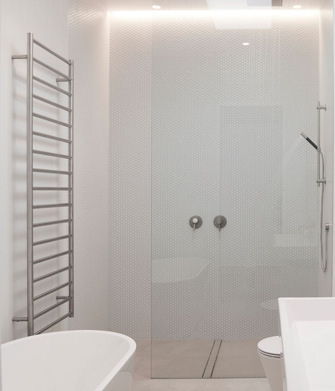 A monochromatic scheme was chosen for the bathrooms to impart a sense of pure simplicity.