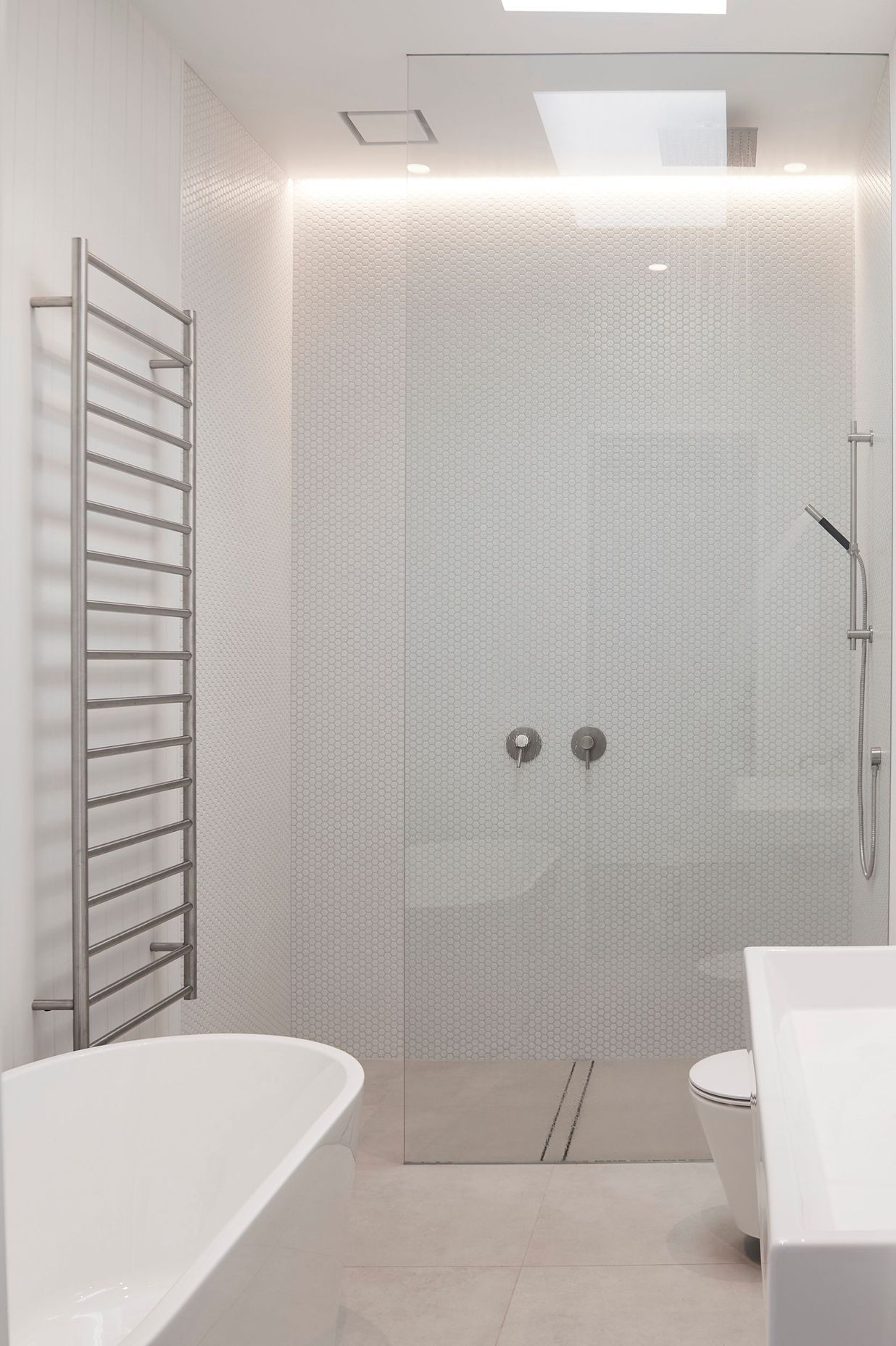 A monochromatic scheme was chosen for the bathrooms to impart a sense of pure simplicity.
