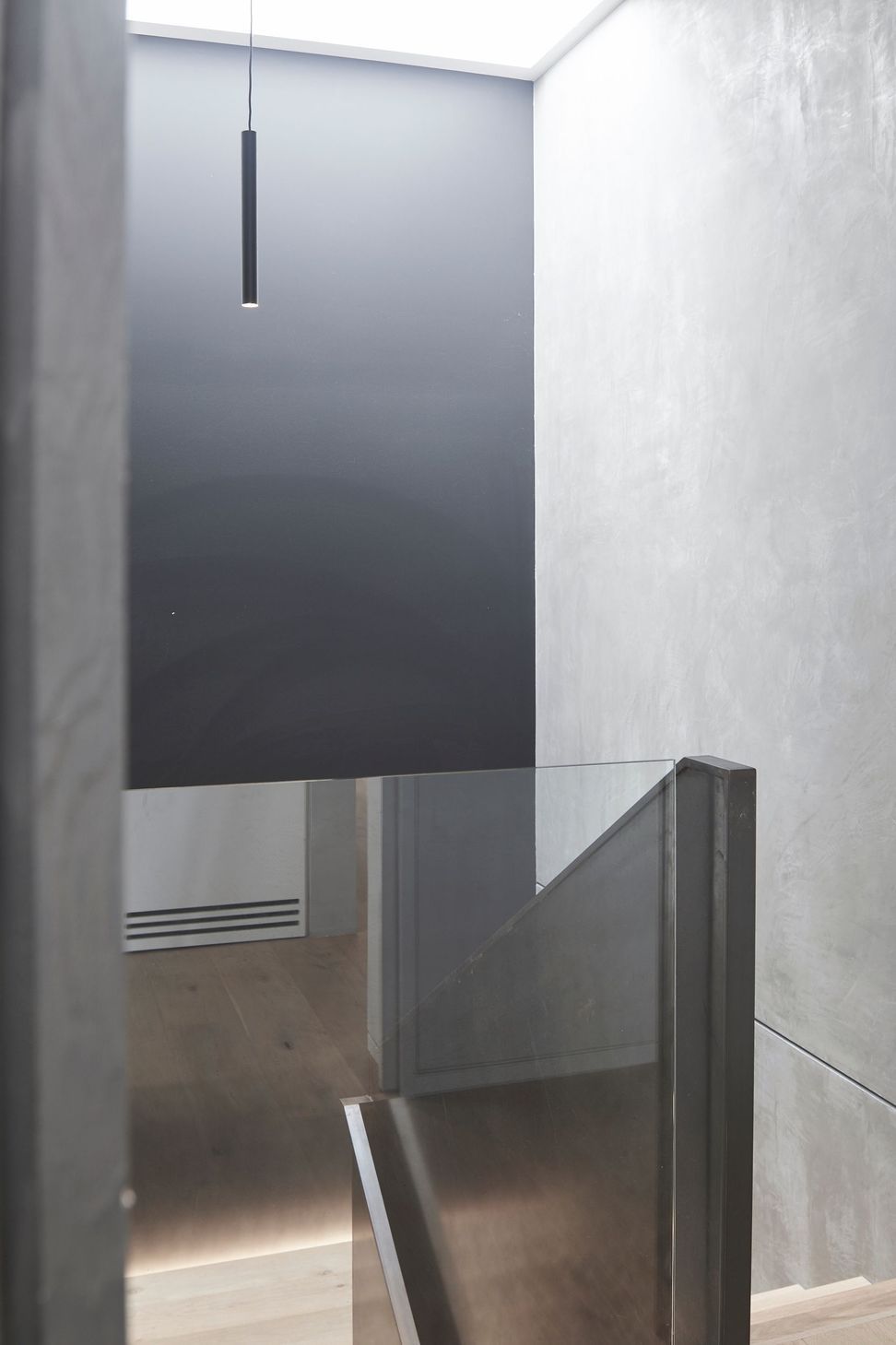 A large skylight admits ample natural light into the stairwell, which accesses the garage and media room.