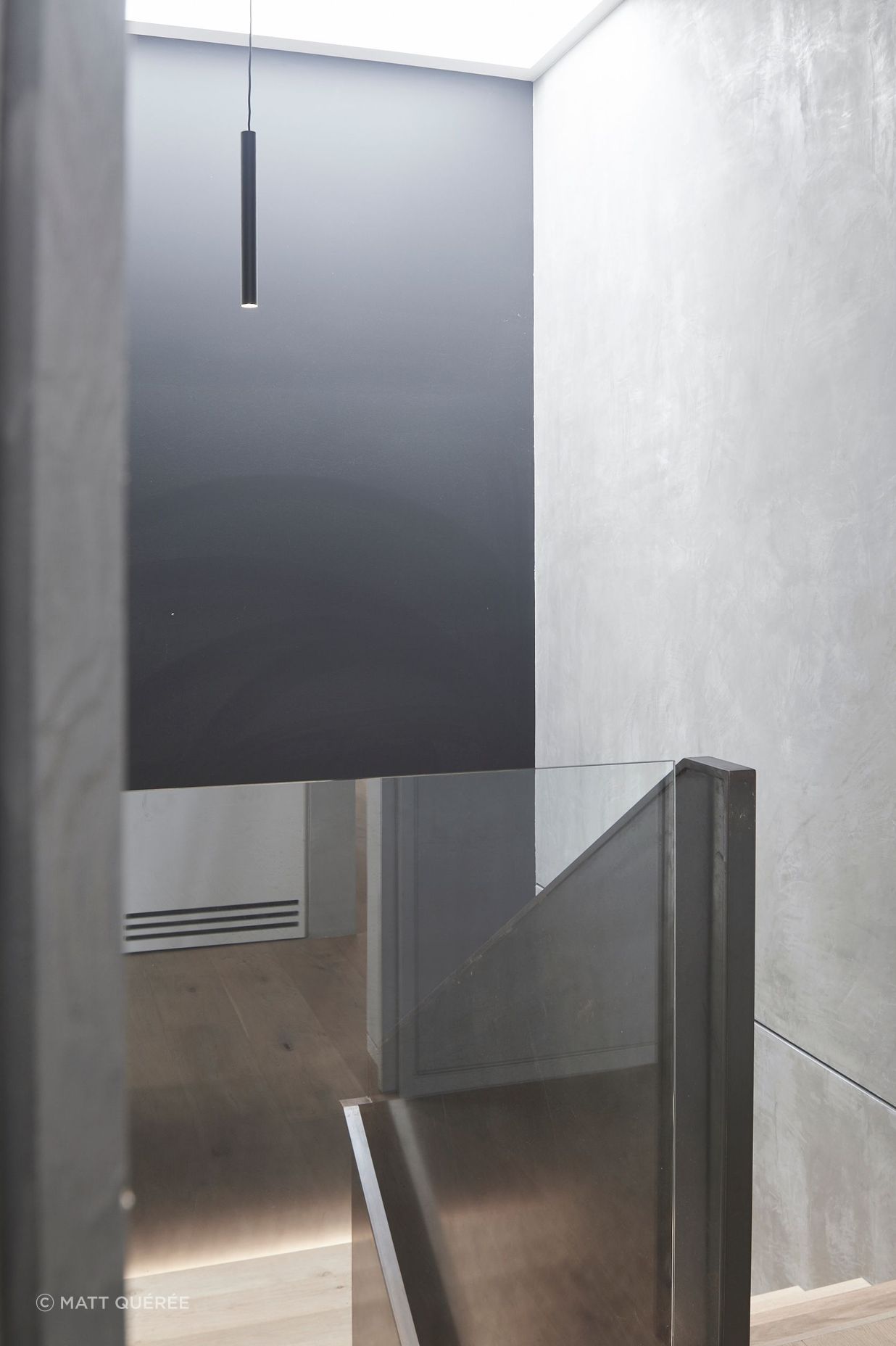 A large skylight admits ample natural light into the stairwell, which accesses the garage and media room.