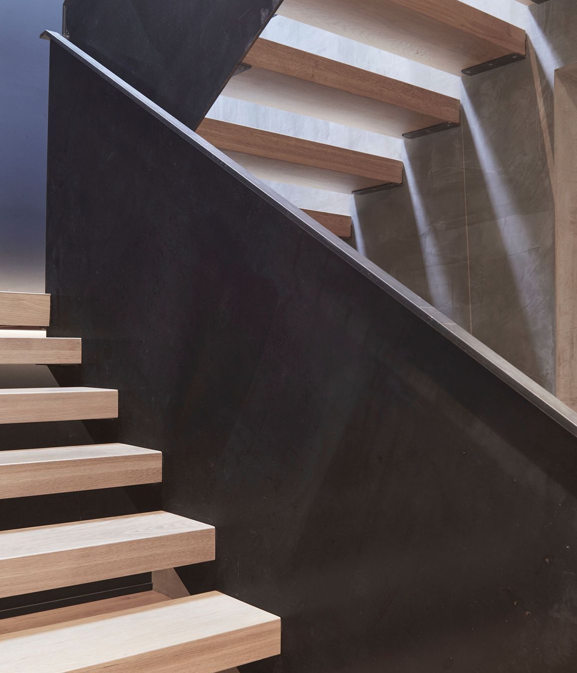 Timber treads help to visually soften the metal balustrades and concrete walls.