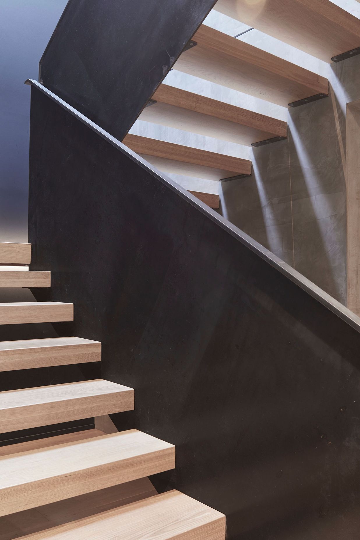 Timber treads help to visually soften the metal balustrades and concrete walls.